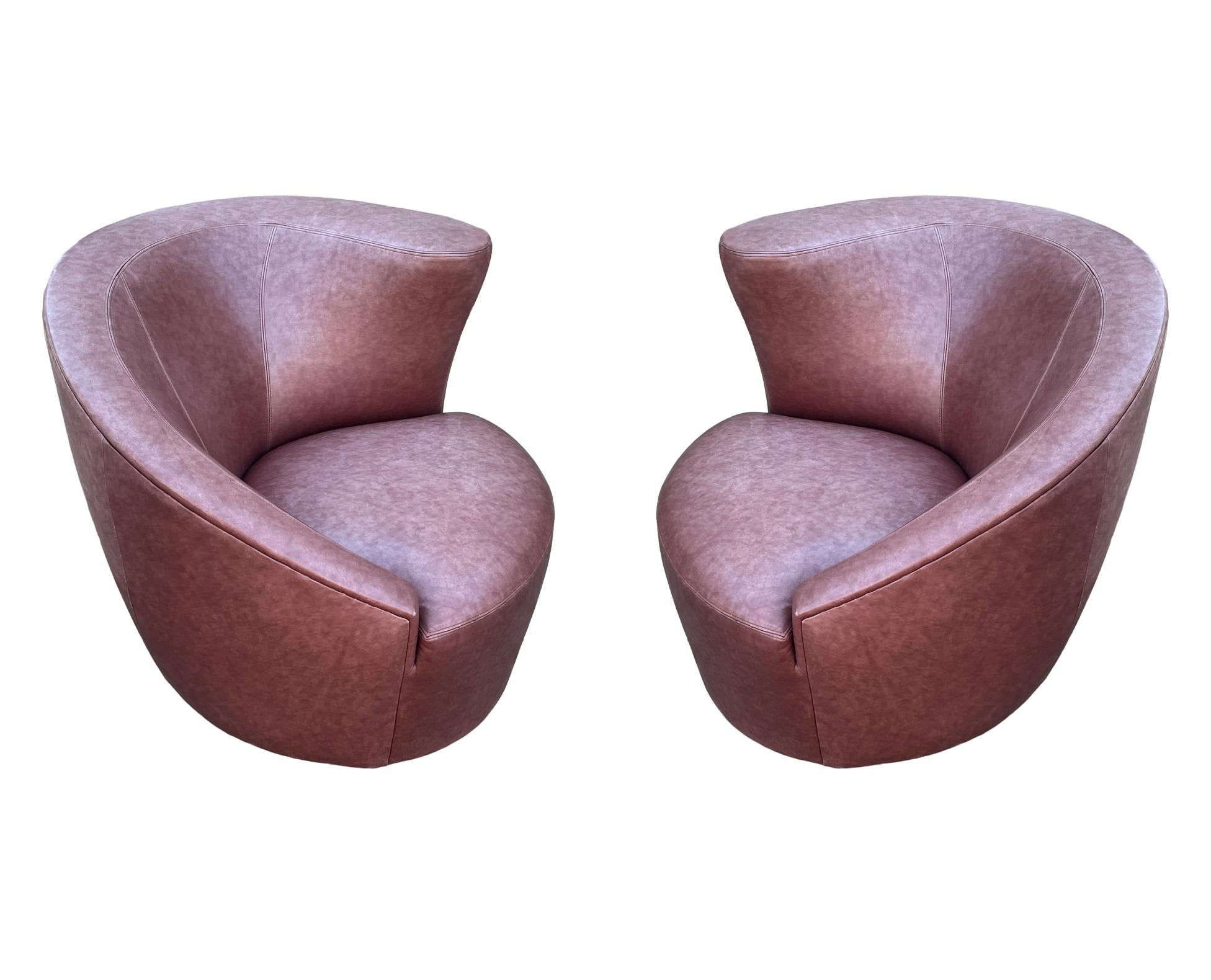 An authentic pair of nautilus chairs designed by Vladimir Kagan and produced by Directional. These are covered in their original leather. Leather is in poor condition, minor scuffs and one cut in chair seat. Recovering is recommended and priced