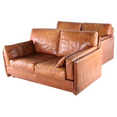 Pair of leather Roche Bobois loveseats