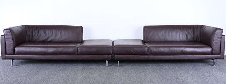 A pair of luxurious chocolate brown leather sofas on chrome bases. These gorgeous post-modern sofas can be used in various arrangements, as shown in images. The Italian sofas are labeled 