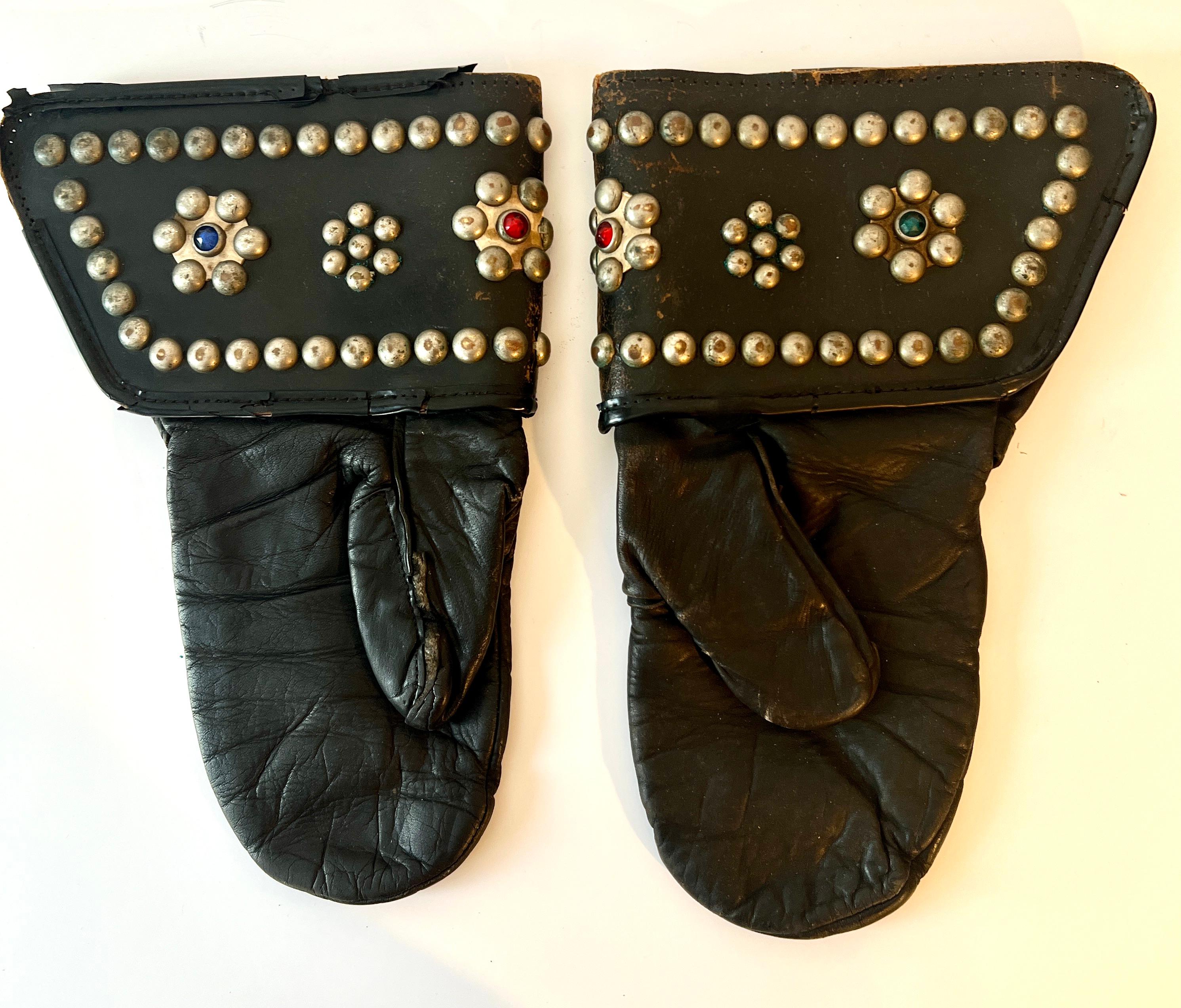A pair of leather motorcycle gauntlets in the style of Harley Davidson.  The pair have a wonderful patination and have studs with beads.

A compliment to any collection or decorative item or the motor cycle enthusiast and aficionado.

We have found