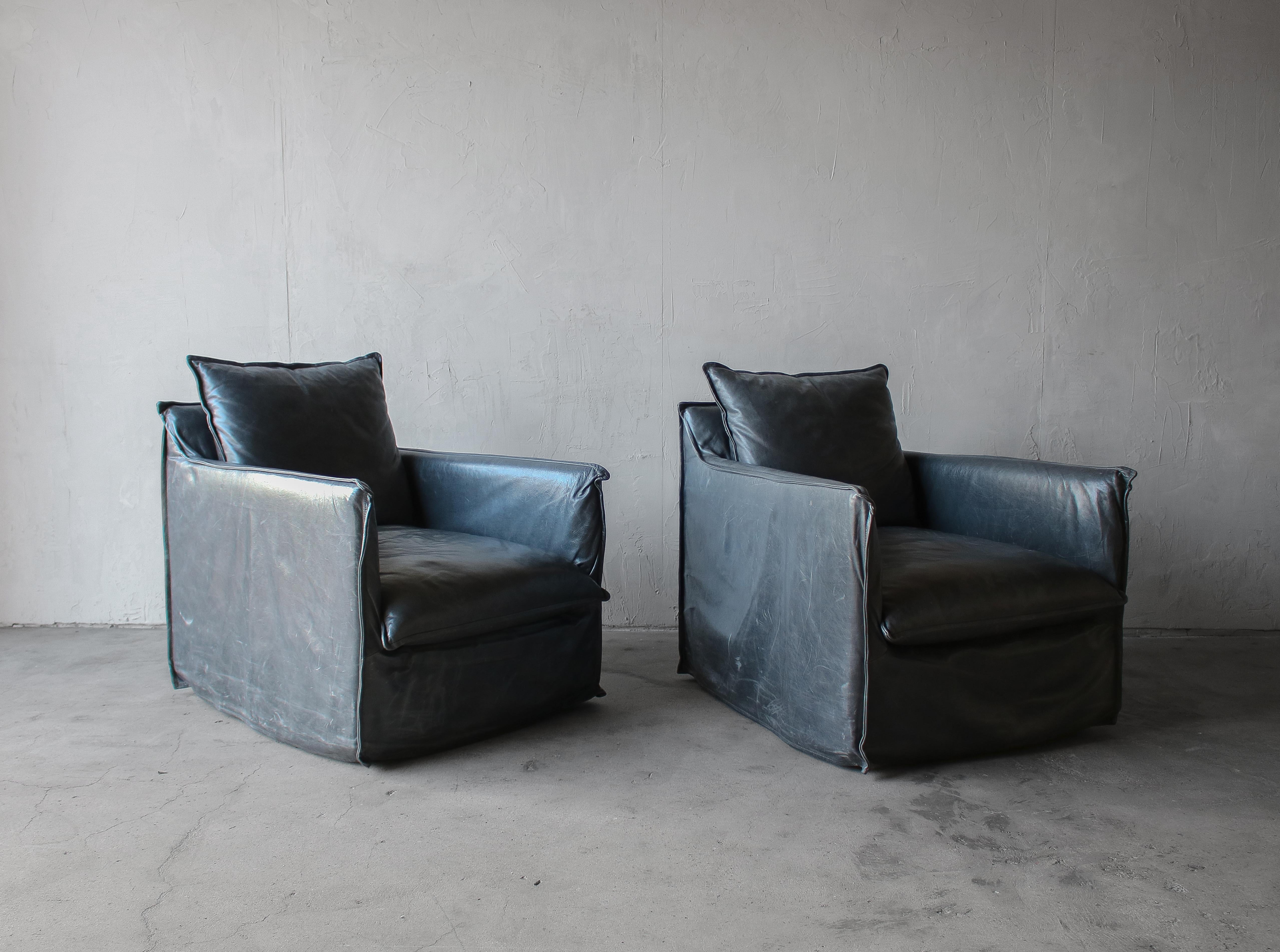 Nice pair of leather swivel chairs.  Chairs feature a unique leather slipcover giving them a real welcoming, sacky feel.  Leather is butter soft in a dark smokey blue, a real cross between navy and charcoal.  Extra deep and extra