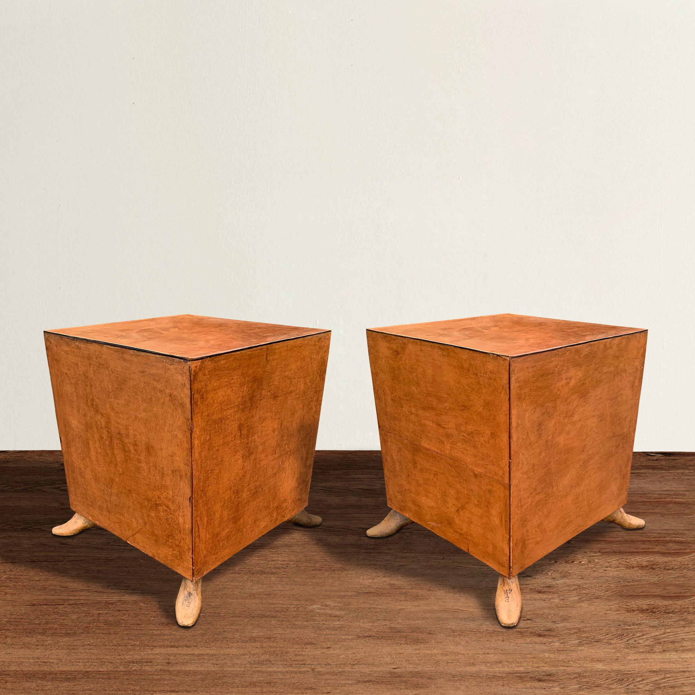 A wonderfully whimsical pair of side tables covered on all sides with a beautifully patinated belting leather, and perched on antique wooden shoe form feet. Tables are also sturdy enough to be used as stools.