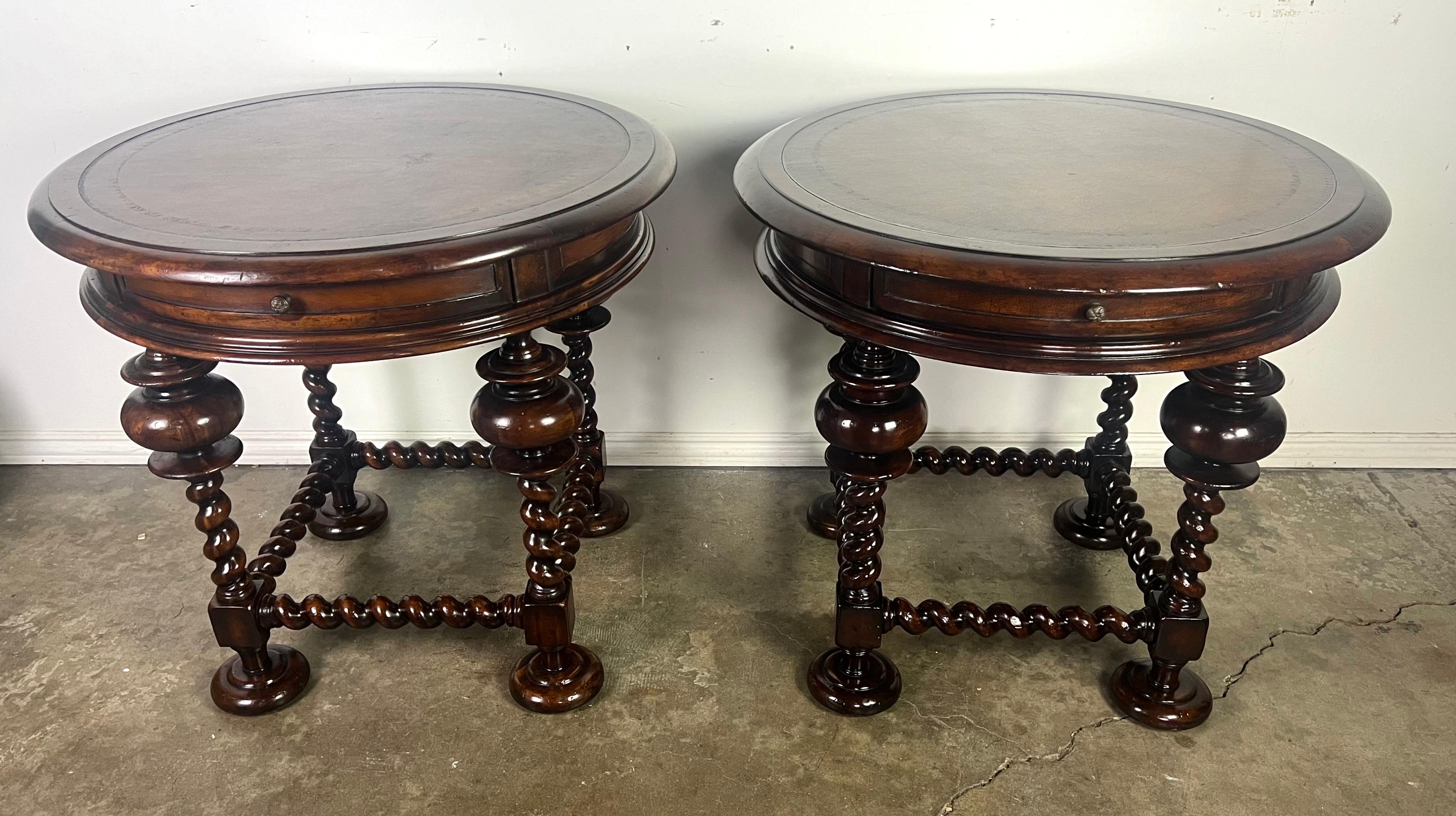 Pair of elegant round accent tables from John Richard, known for their high quality craftsmanship and luxurious designs.  The tables feature rich, dark wood with a polished finish.  The tops have a smooth, rounded edge and a subtle beveled detail