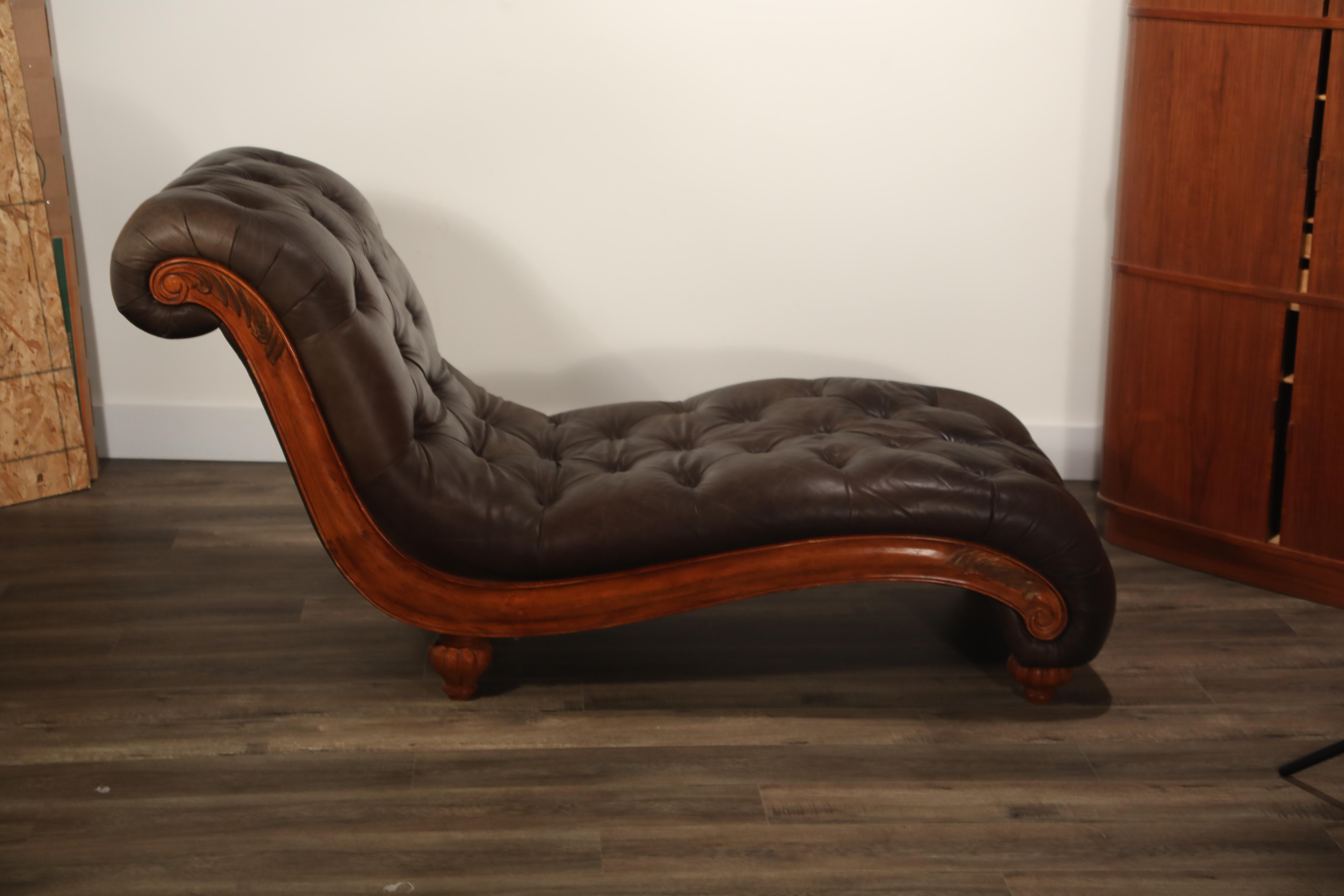 A beautiful pair of tufted leather chaises, with detailed wood frames. These Chesterfield style daybeds are priced individually, but we have a pair available. 

These handsome chaise lounges would be a great addition to a Classic, Mid-Century