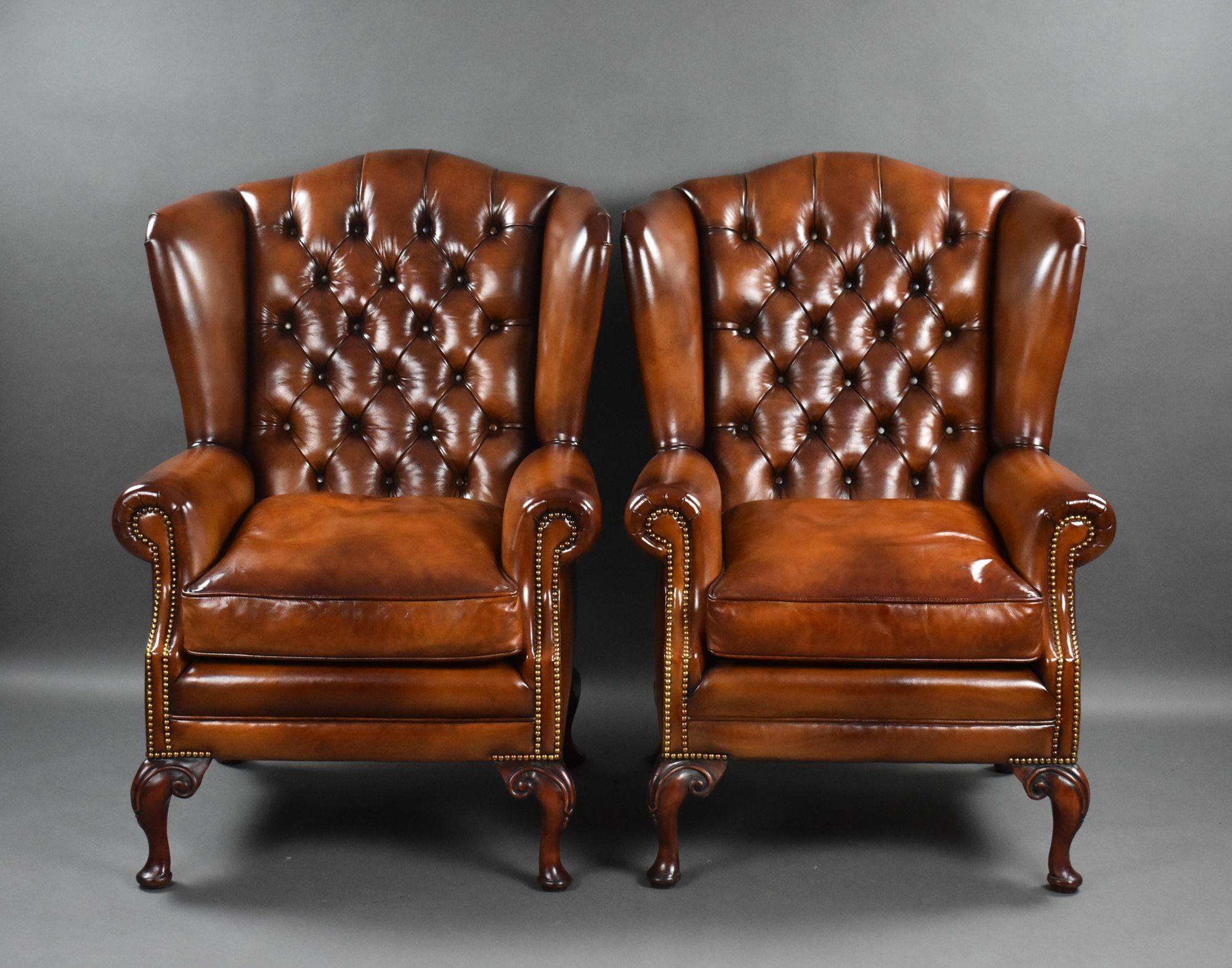 For sale is a good quality pair of antique hand dyed leather wing back armchairs, each with deep buttoned backs and feather stuffed seats, the chairs stand on elegant cabriole legs to the front, and fine legs to the rear. Each chair is in excellent