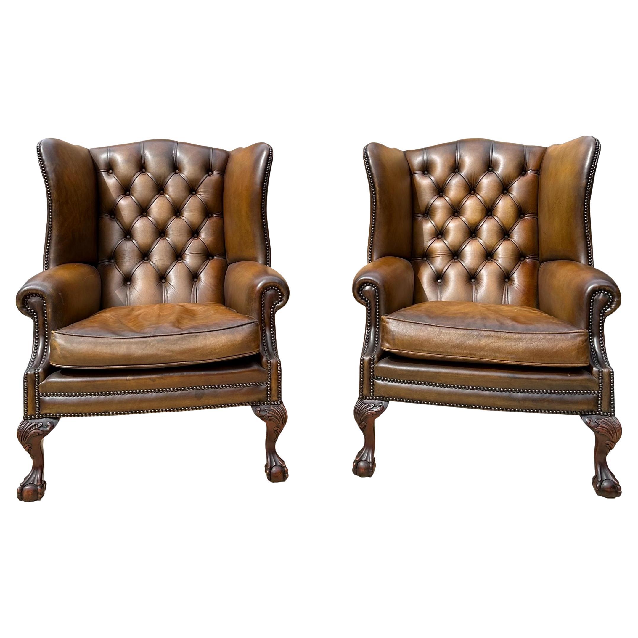 Pair of Leather Wing Back Tufted Chairs on Ball & Claw Feet, English, ca. 1920. For Sale