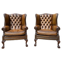 Vintage Pair of Leather Wing Back Tufted Chairs on Ball & Claw Feet, English, ca. 1920.