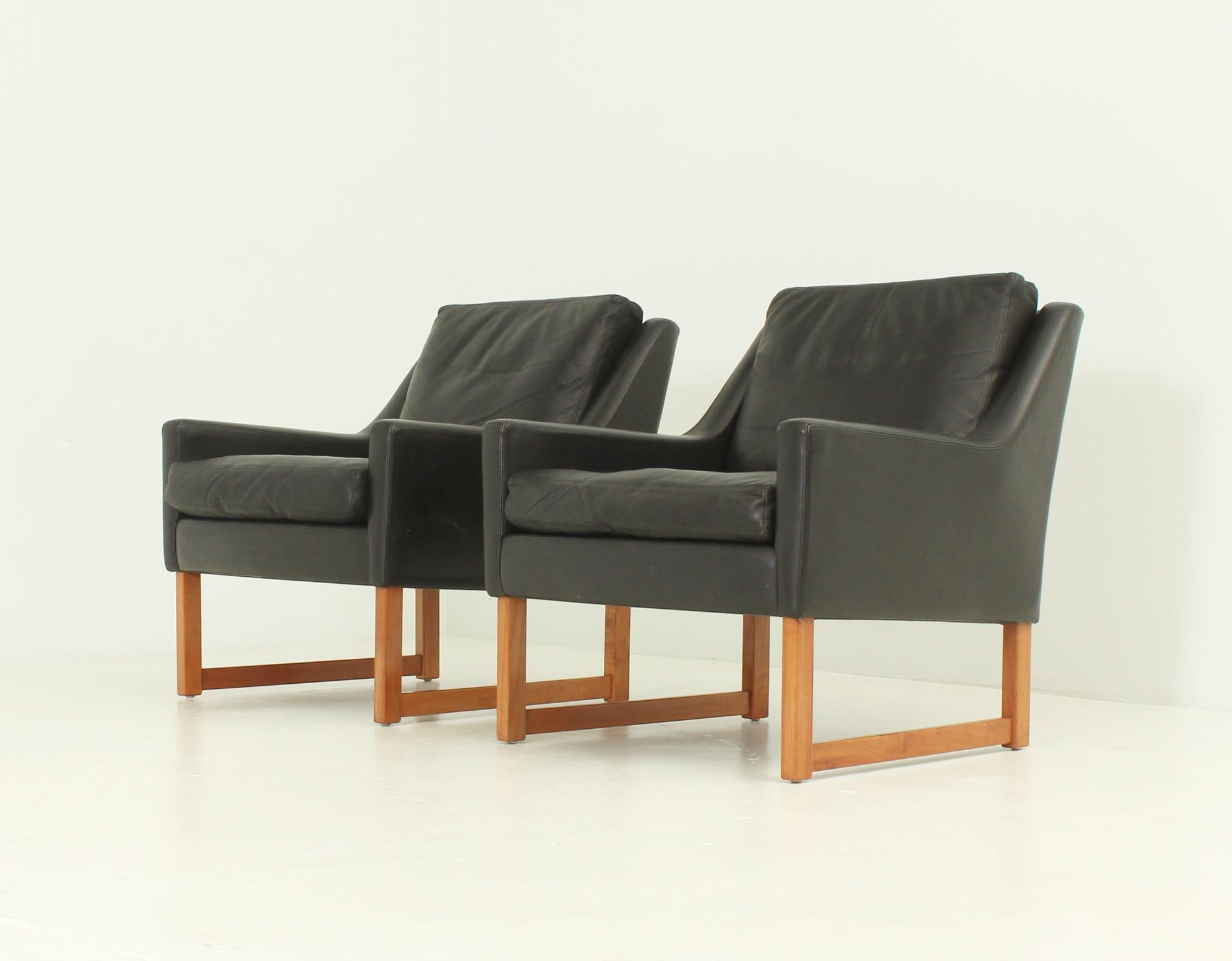 Paire de fauteuils conçus dans les années 1960 par Rudolf Bernd Glatzel pour Kill International, Allemagne. Structure en bois recouverte de cuir aniline noir avec coussins amovibles.