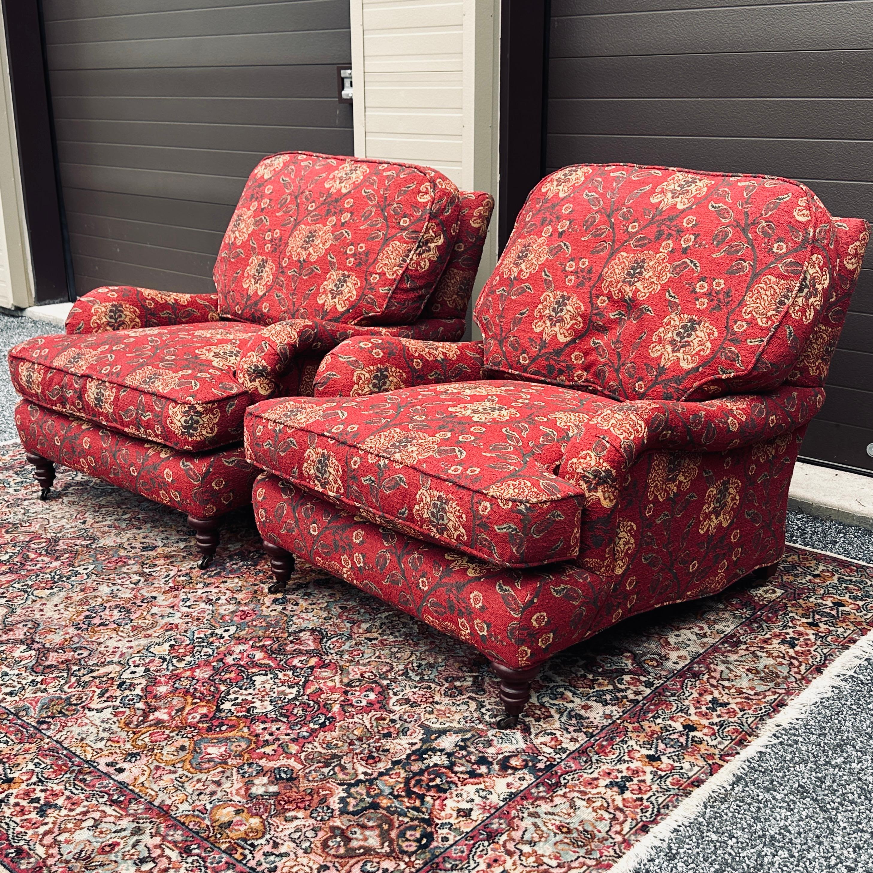 Pair of English roll arm lounge chairs on brass casters in the original nubby floral upholstery. Hand made in the USA by Lee Industries of North Carolina. 