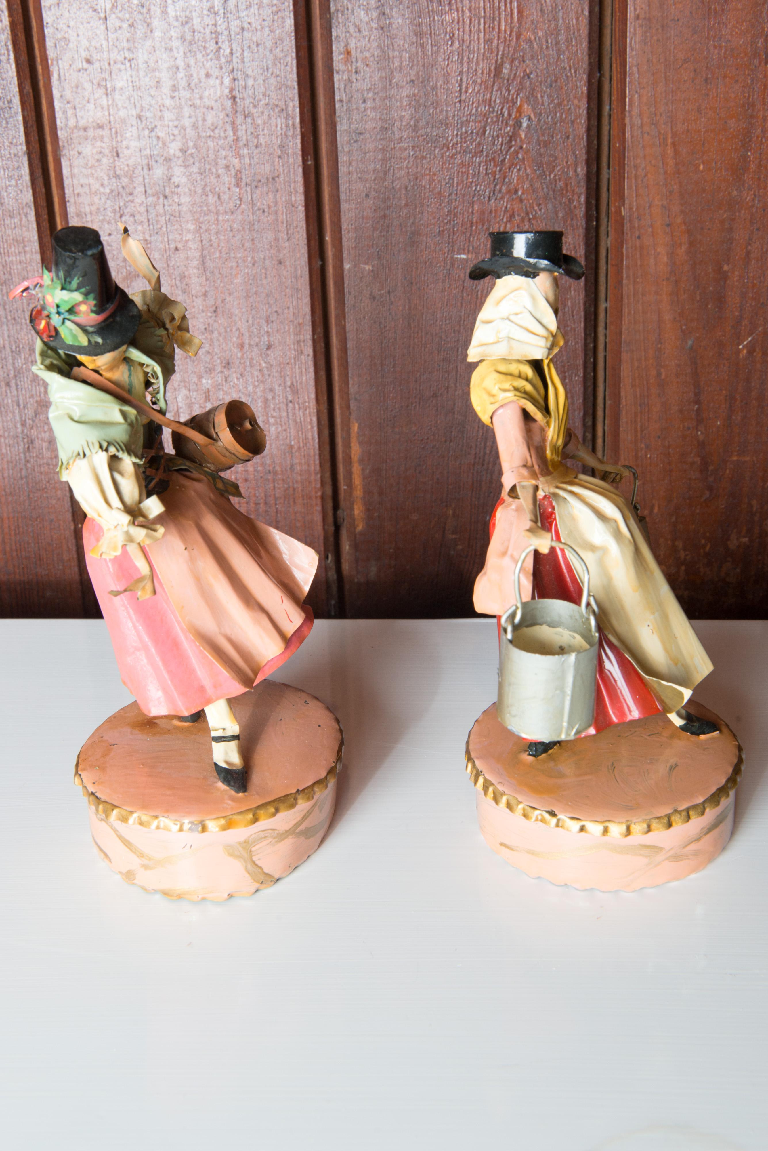Lee Menichetti, (1931- 1997), New York & Palm Beach, well known mid century artist known for his theatre related art. These sculptures are made of hand bent and hand painted sheet brass. An Austrian Tyrolean maid with a tall hat and a brandy keg. A