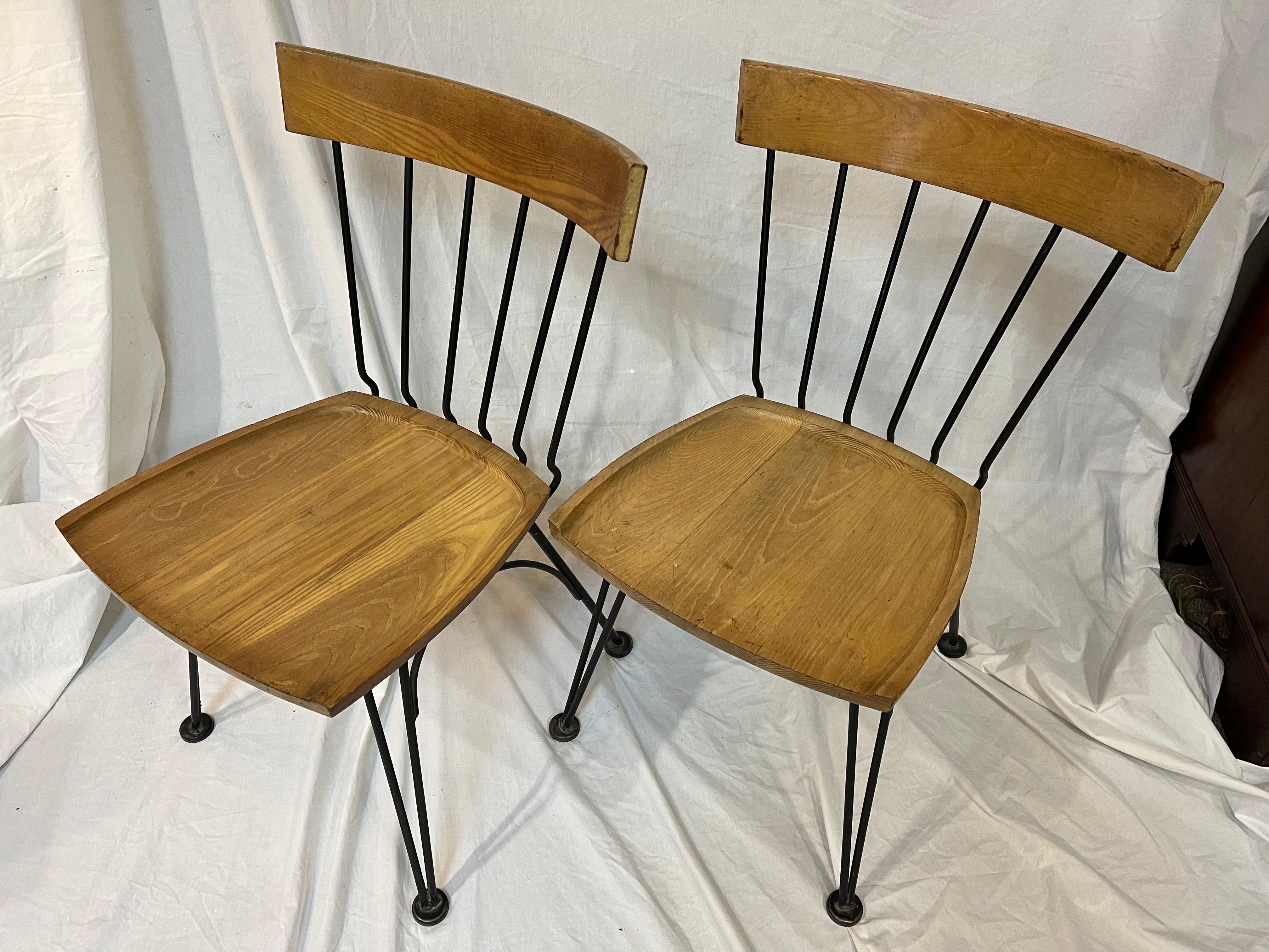 A pair of Mid-Century Modern, circa early 1950s Allegro chairs by Lee Woodard. This pair of sturdy wood and iron chairs is supremely comfortable and exhibits all of the hallmarks of great mid century design. For a bit of history on Lee Woodard and
