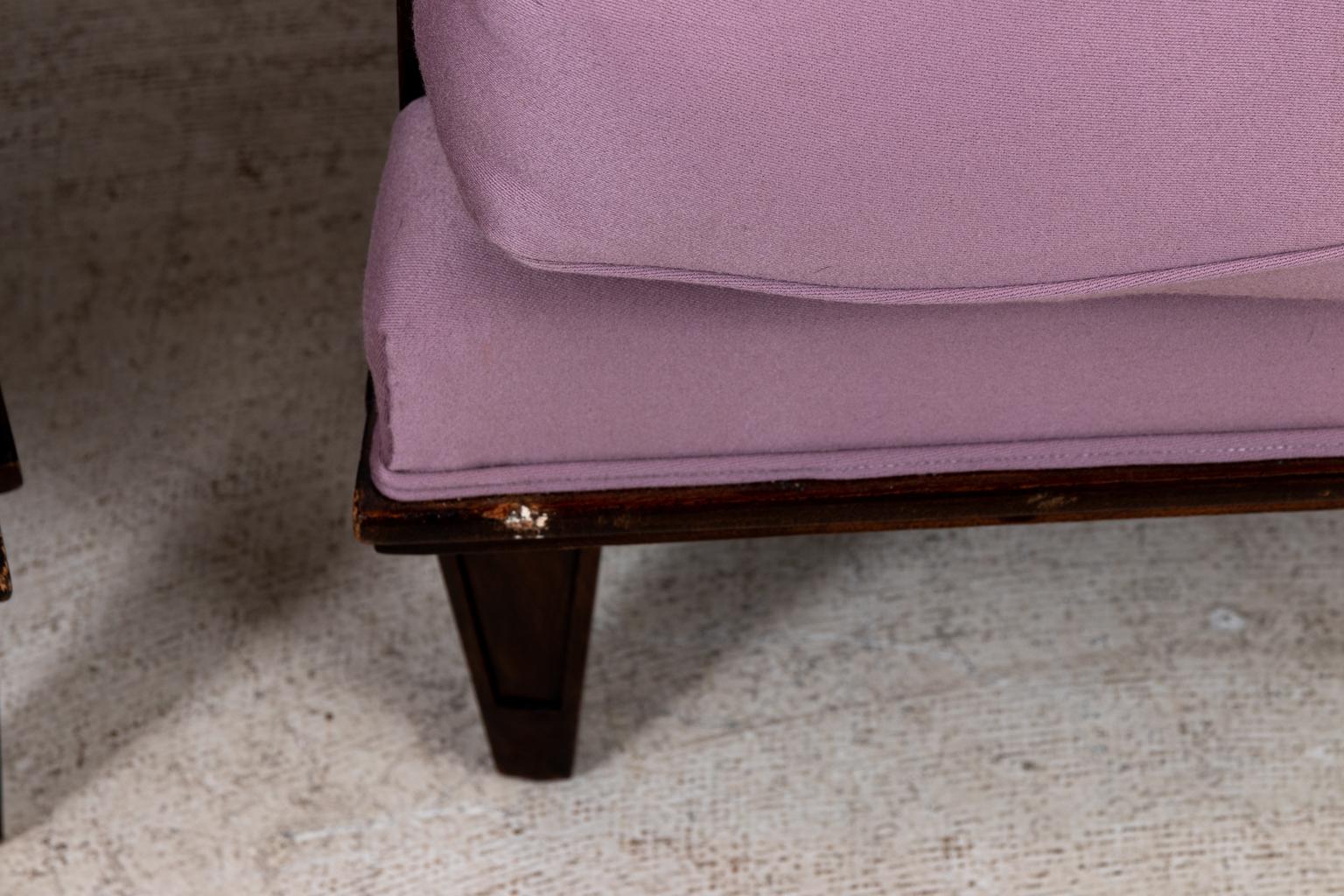 Circa 1940s pair of armchairs by Jules Leleu in the Art Deco style with polished Walnut frames, square shaped backs, and lilac satin upholstery. The upholstery also features tonal grosgrain trim. Made in France. Please note of wear consistent with