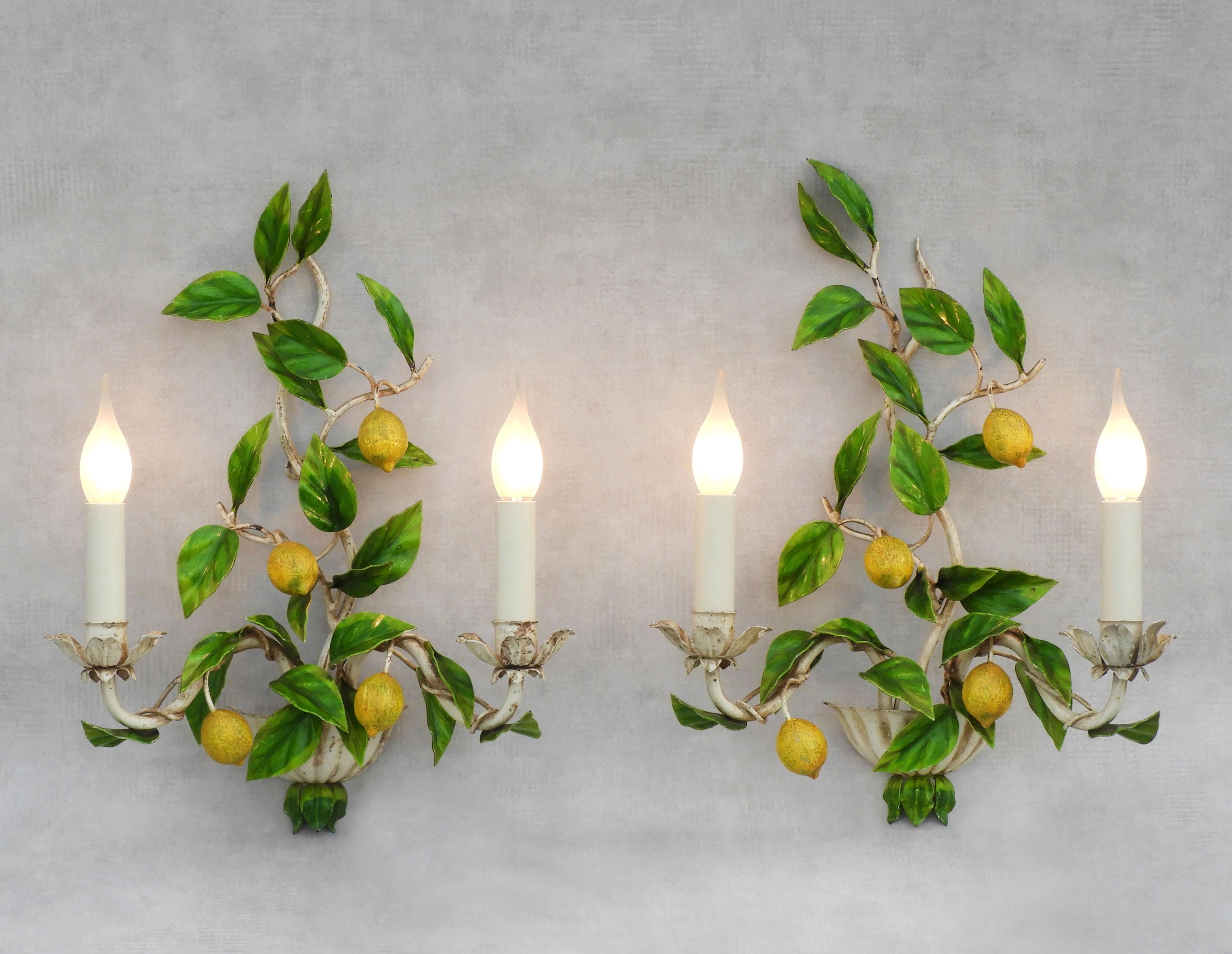 Charming Lemon Tree wall light sconces from Maison Honoré C1960s France. 
A delightful pair of french enamelled toleware lights with luscious lemon fruits and glossy foliage and each with two ‘faux’ candle lights. In good vintage condition,