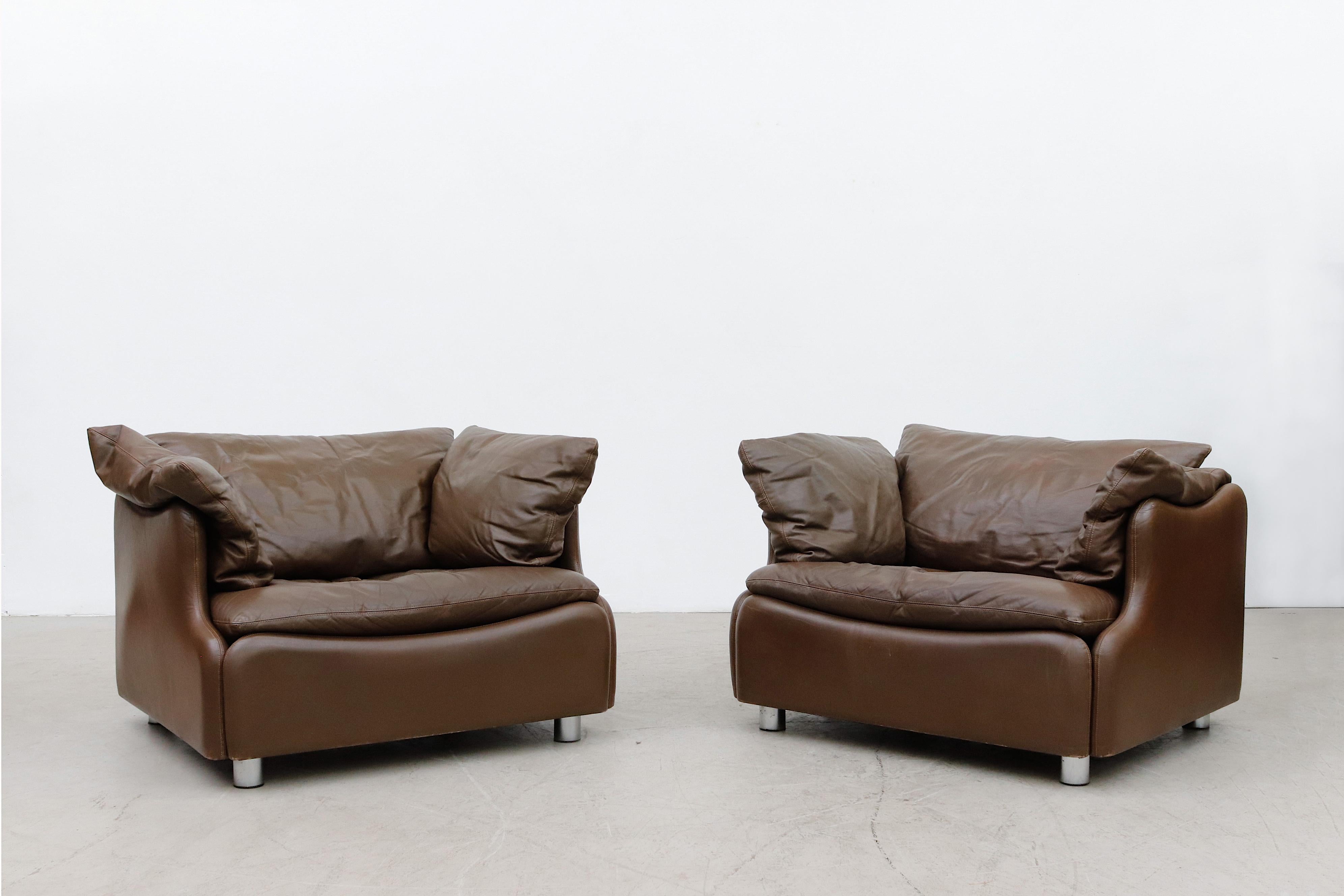 Pair of Leolux Wave Frame Lounge Chairs in Brown Leather. Beautifully made, In original condition, with some wear. Came from the original owner, with original receipt and catalog page. A matching 3 seater sofa also available and listed separately