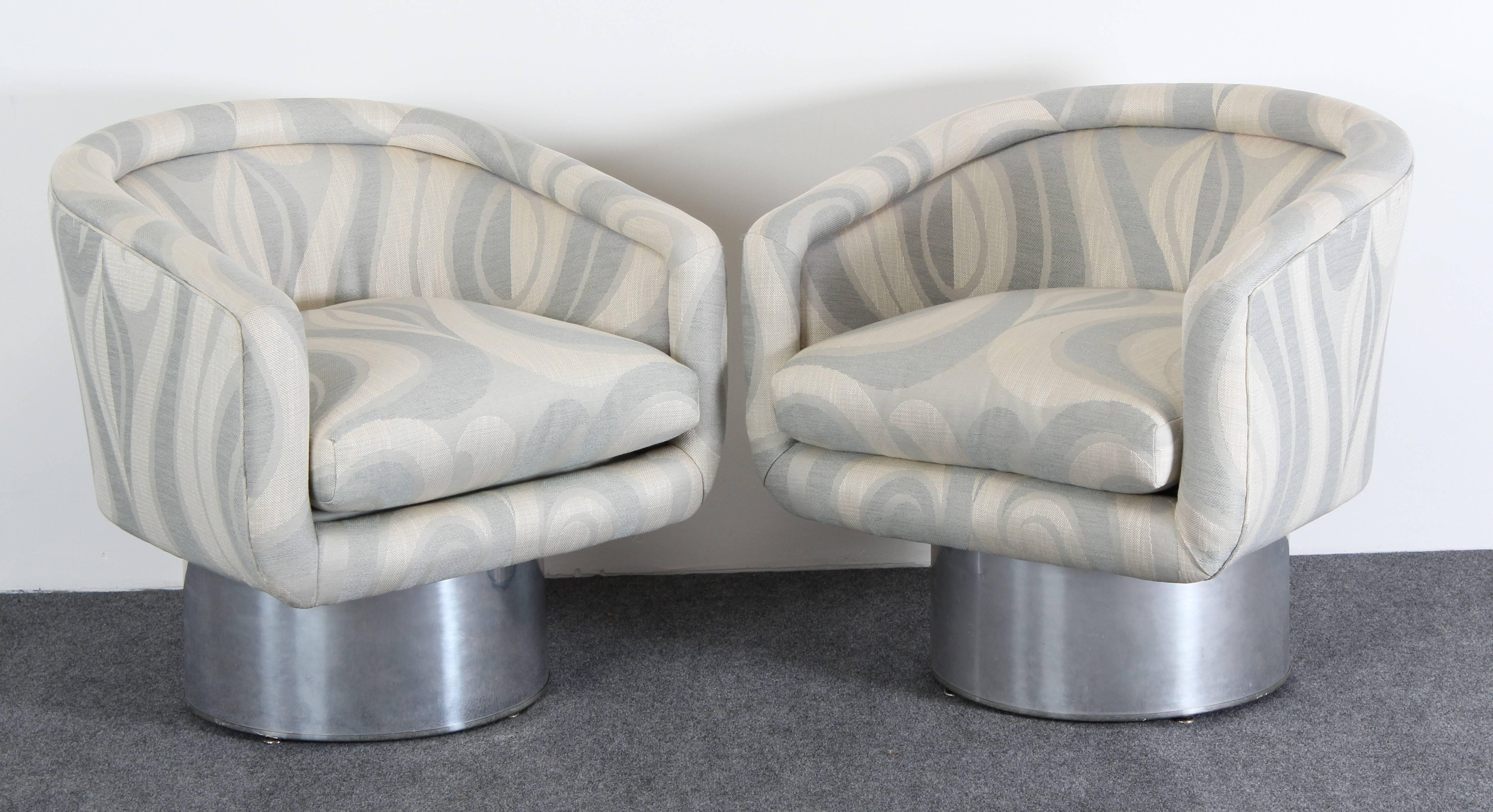 A stunning pair of Leon Rosen for Pace Swivel Lounge Chairs, circa 1970s. The pedestal base is made of polished solid sheet aluminum. The fabric is in overall very good condition. The chairs are structurally sound and nicely upholstered ready to be