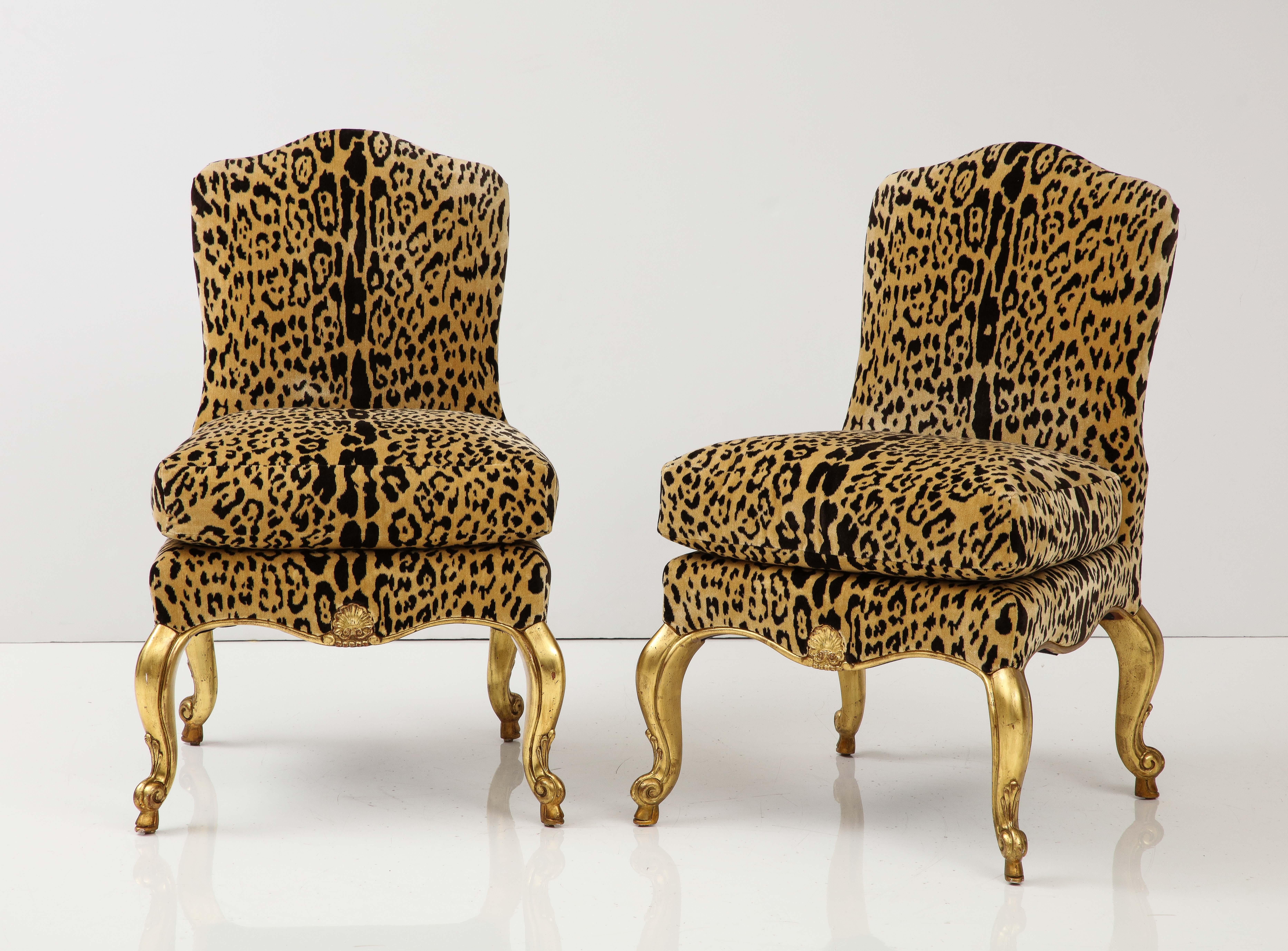 Add star power to any room with this dynamic duo! These slipper chairs in the Louis XV style feature a curved tight back with a loose seat cushion and a scalloped apron raised on gilt wood cabriole legs. The chairs have been recently reupholstered