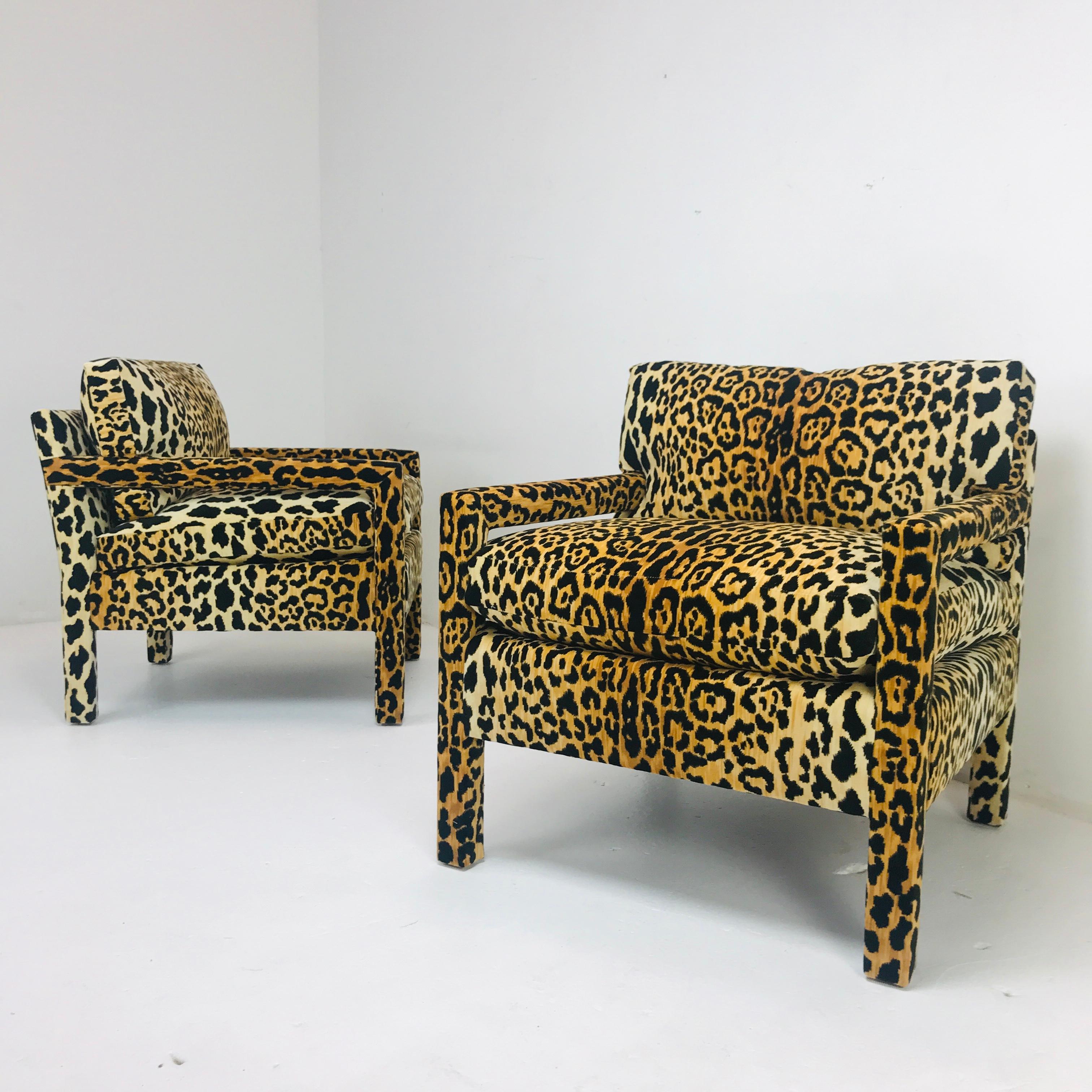 Pair of custom stylish parsons armchairs in the style of Milo Baughman. Newly upholstered in a fun-sophisticated leopard upholstery fabric. Down wrapped seat cushion with down back cushion make these chairs ultra comfortable. Available at $5800 (as