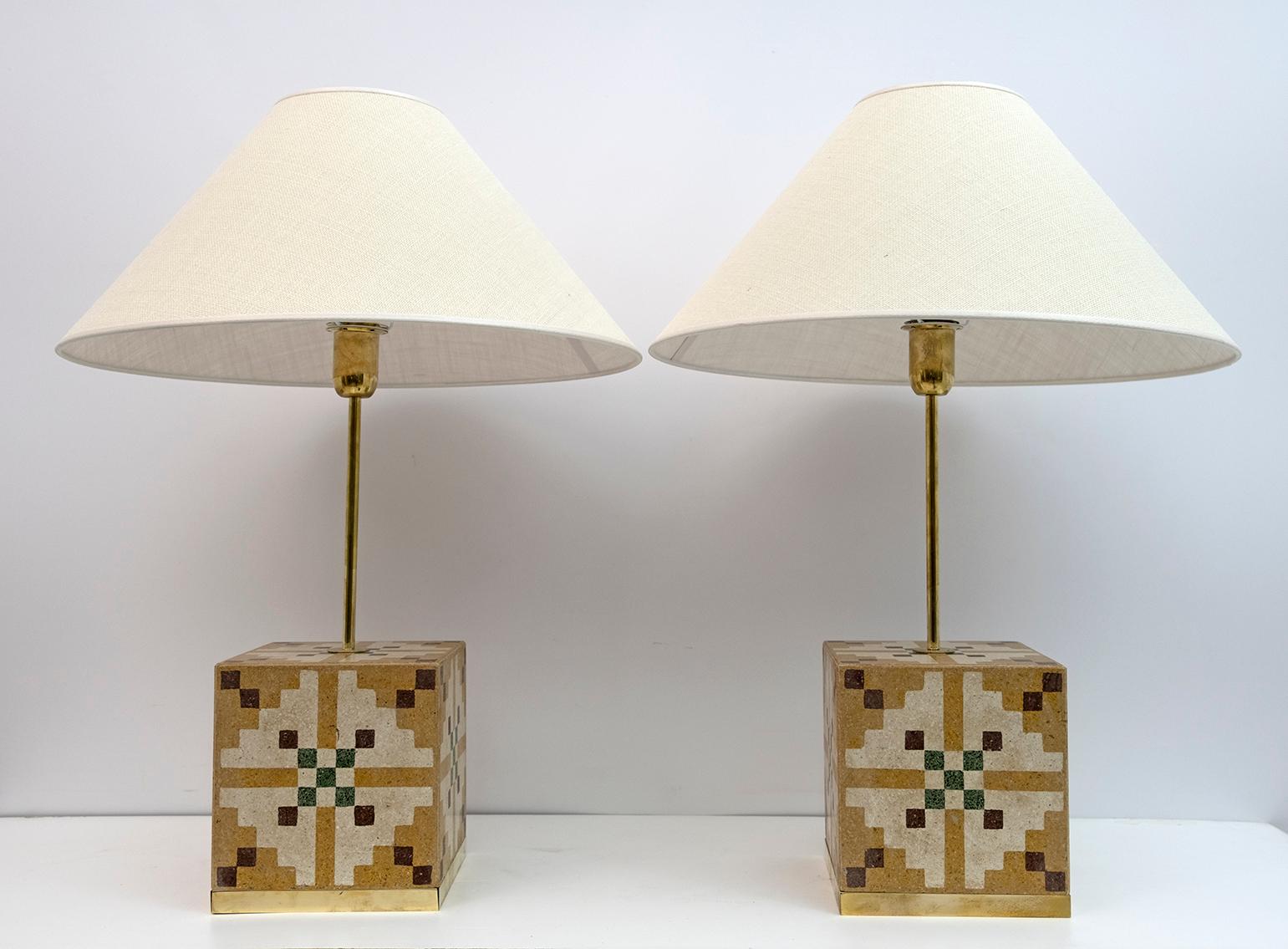 Pair of Italian Art Nouveau Vintage cementite table lamps.
The lamps were made in Italy in the 1920s using cement tiles with geometric decorations typical of Art Nouveau, the frames on the base are made of brass, including the lampshade
