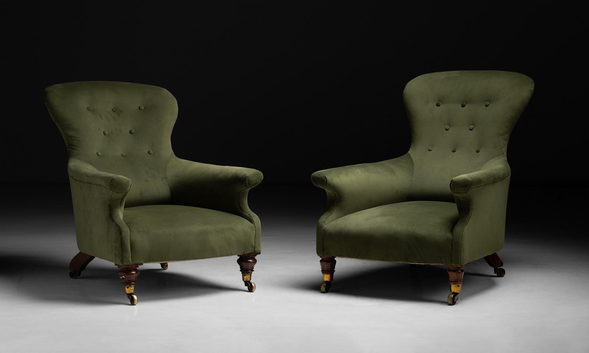 Pair of Library Chairs in Velvet, England, circa 1910

Low, angled form, newly upholstered in velvet, on turned mahogany legs with brass castors.

Measures 27.5”w x 32”d x 33”h x 12”seat / 28”w x 35”d x 41”h x 13”seat.