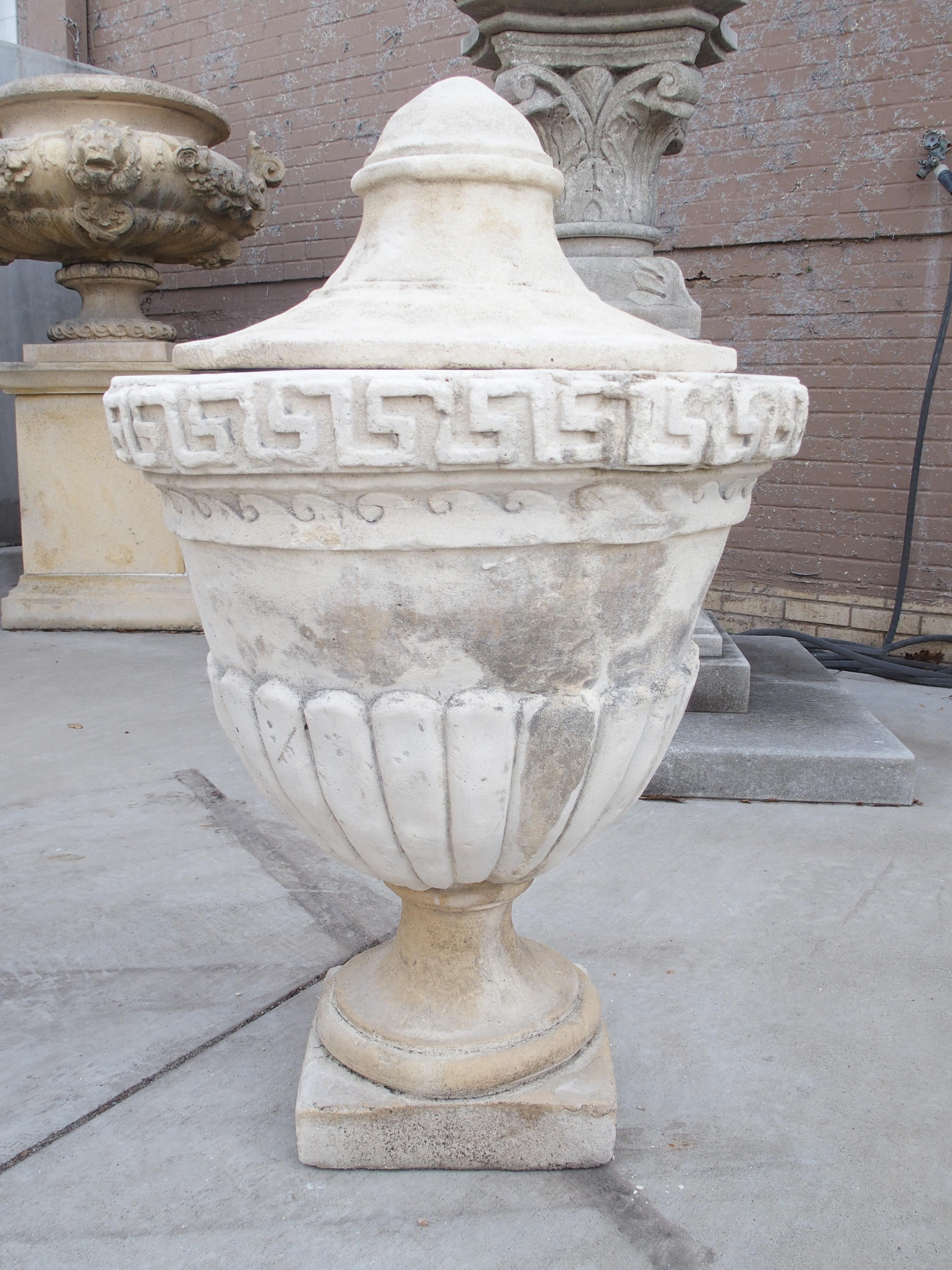 Neoclassical Pair of Lidded Cast Limestone Greek Key Urns from Southern Italy
