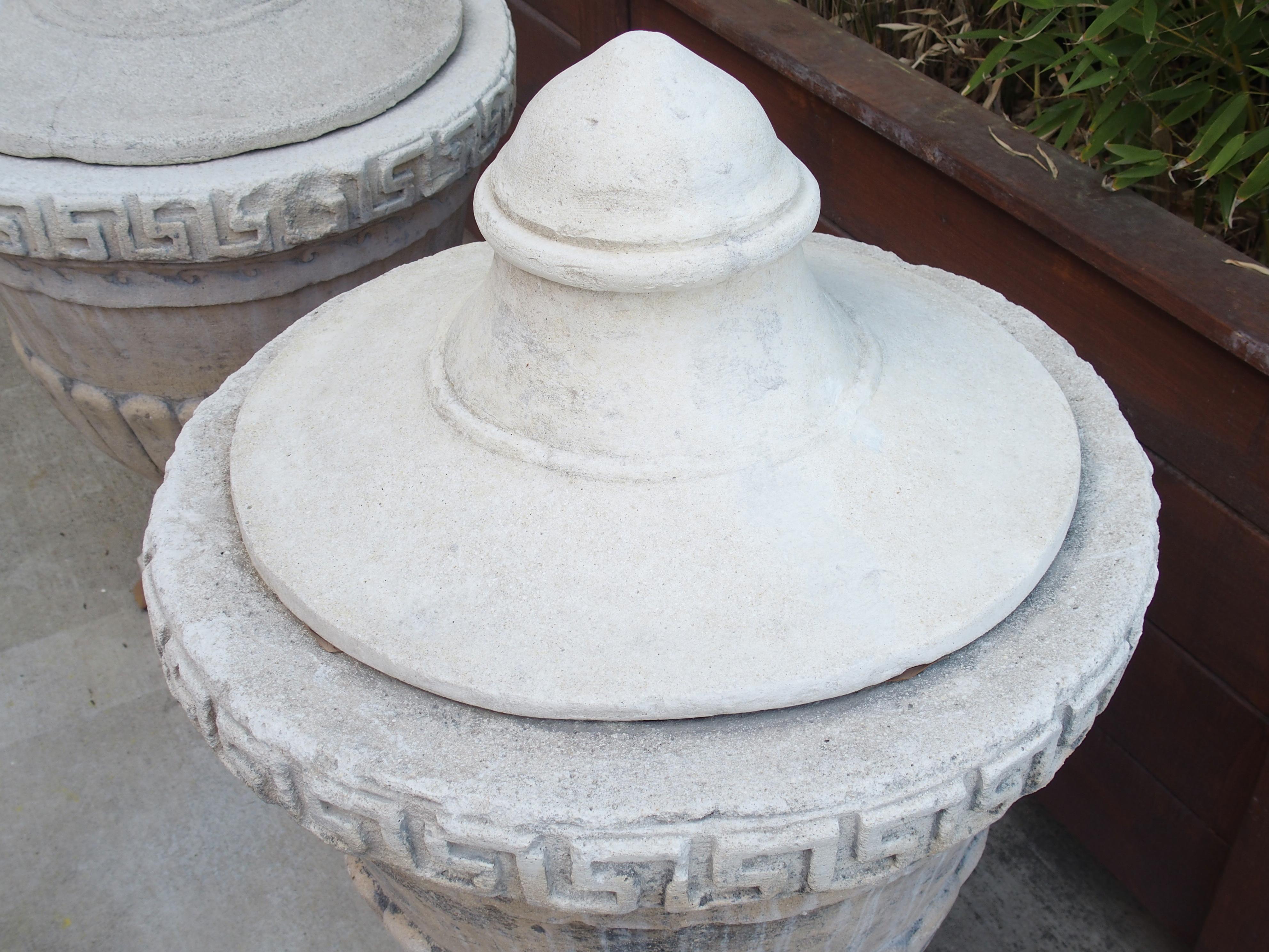 Contemporary Pair of Lidded Cast Limestone Greek Key Urns from Southern Italy For Sale