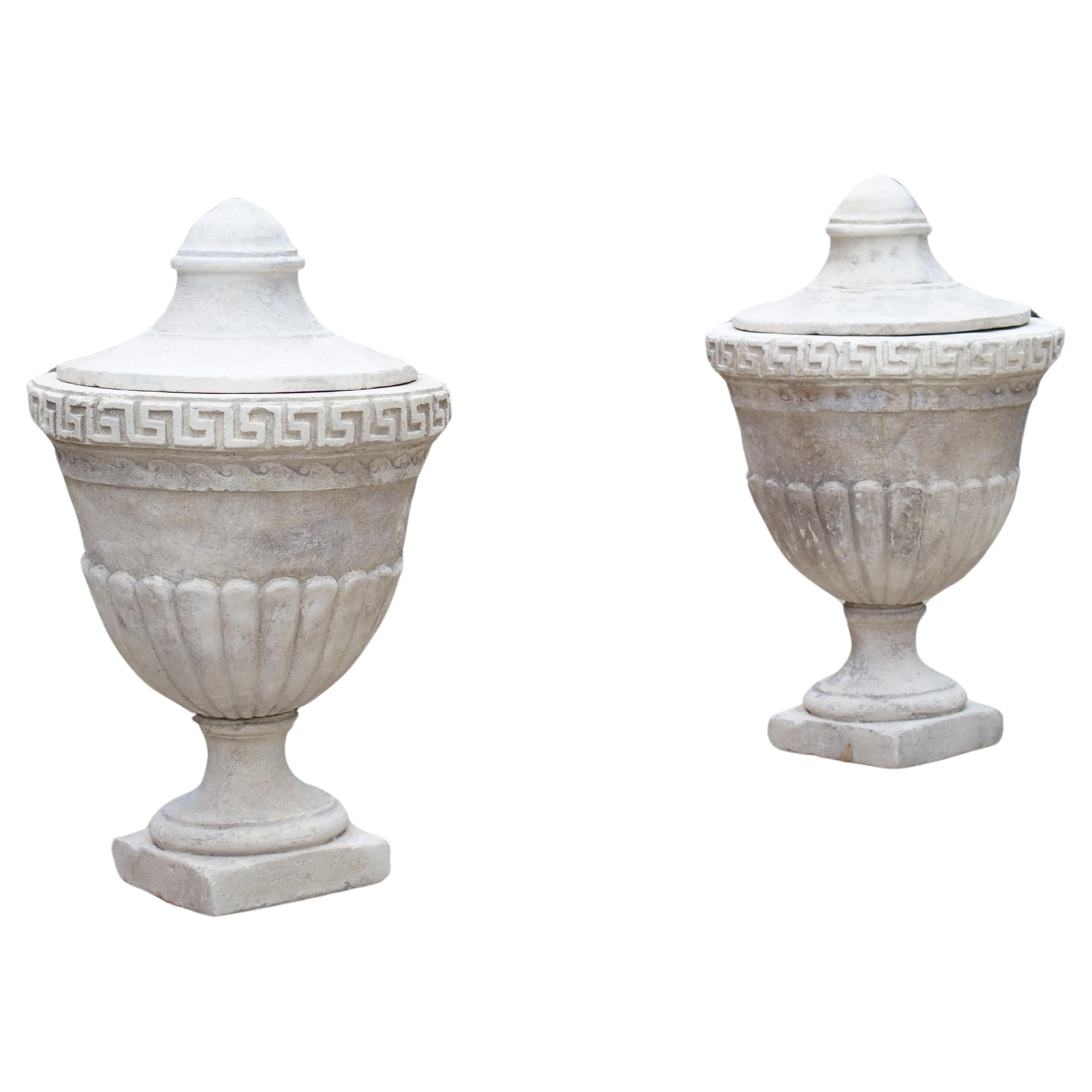 Pair of Lidded Cast Limestone Greek Key Urns from Southern Italy