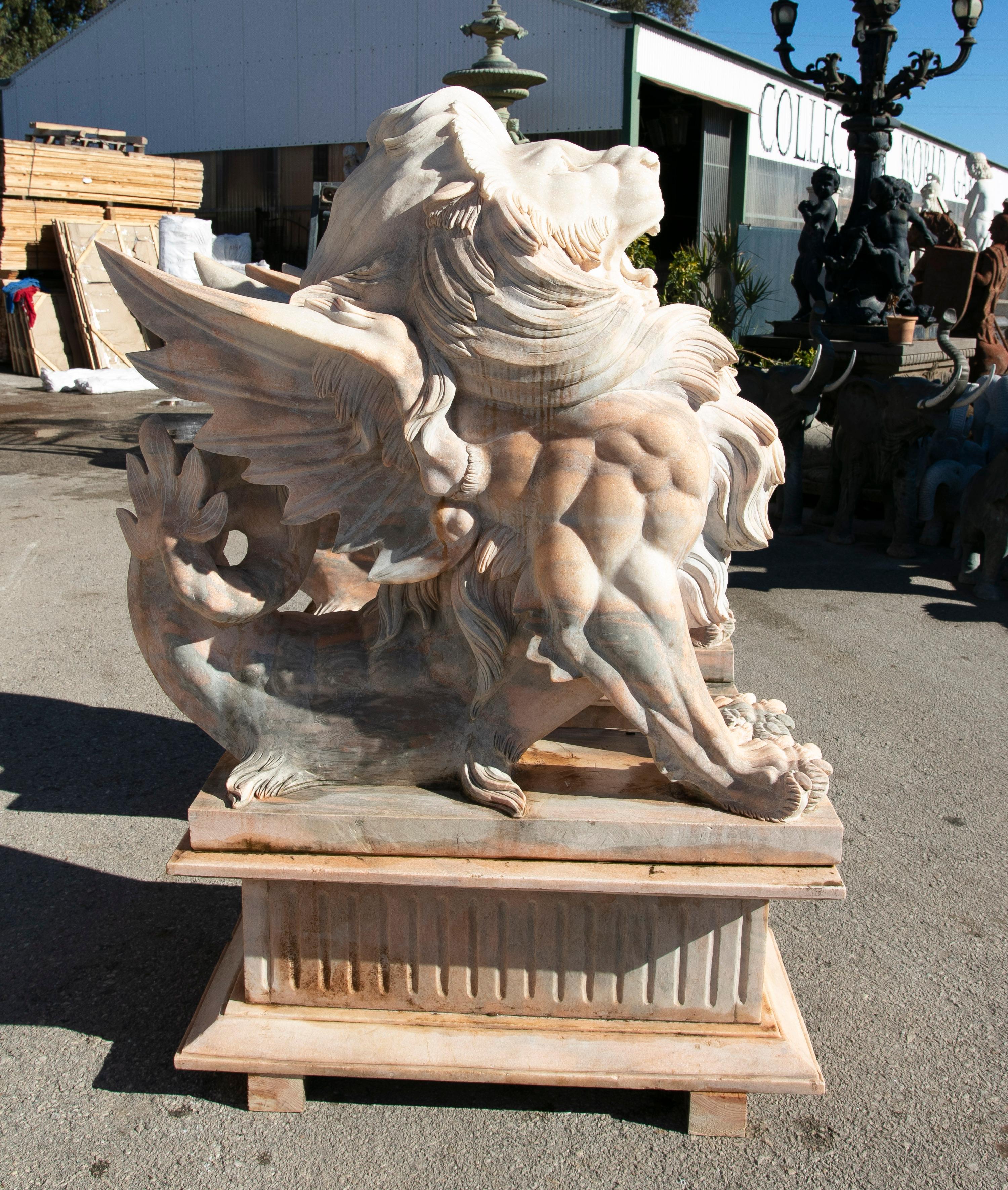 Pair of life-size 1990s hand-carved Rosetta pink marble winged lions with bases.