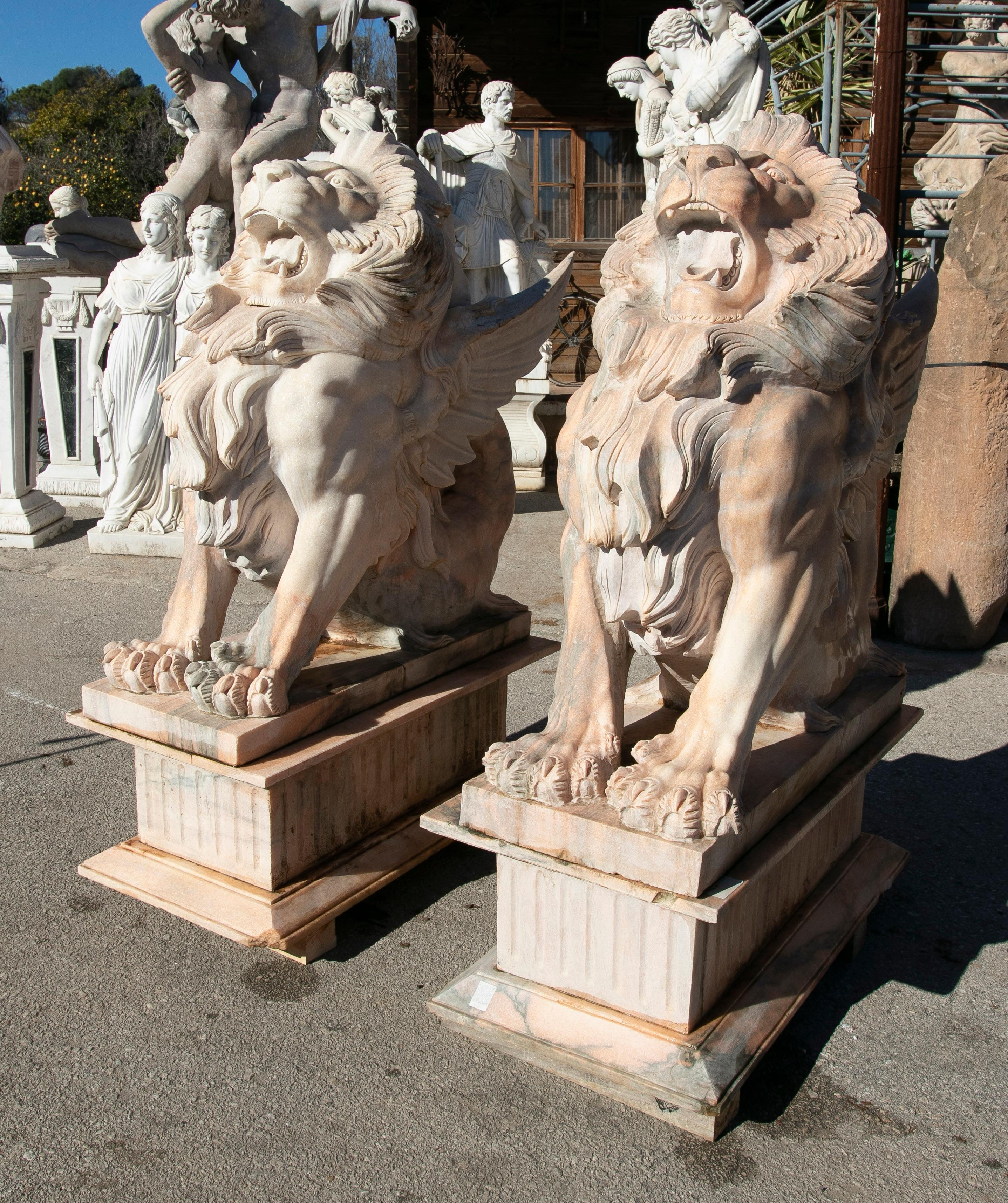 20th Century Pair of Life-Size 1990s Hand-Carved Rosetta Pink Marble Winged Lions w/ Bases