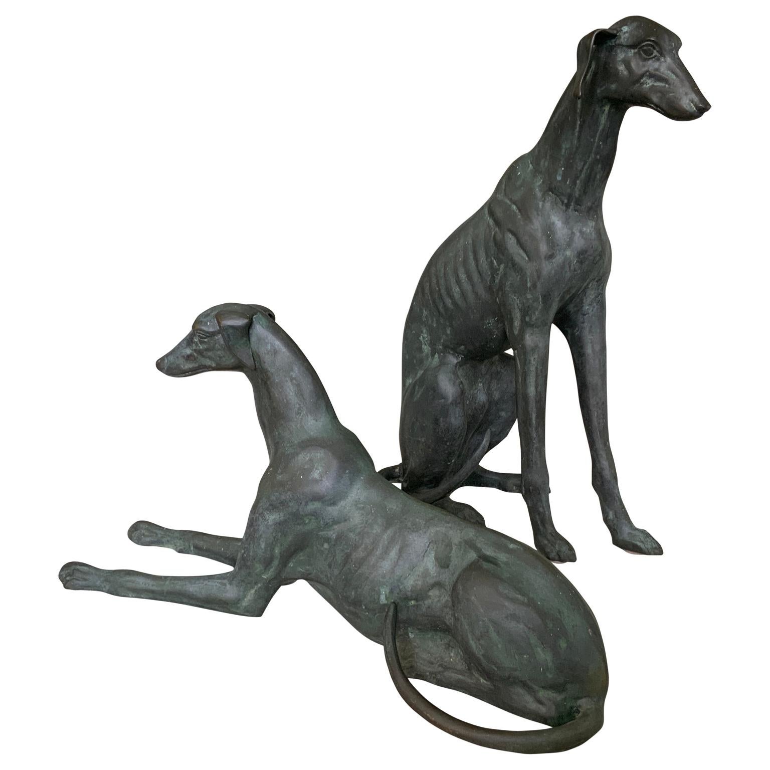 A great pair of life-size bronze Whippet dog sculptures. Wonderful bronze, and patina is great. Nice detail. One sitting, one lying down. Sold as a pair of 2 23” tall sitting dog. 23.50” long lying dog.
