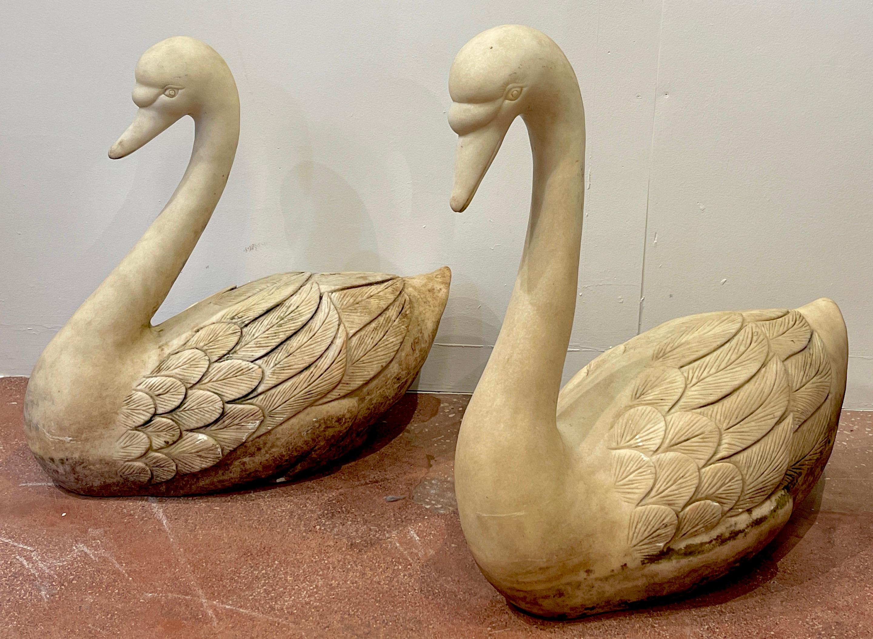 Pair of life size carved marble garden swans, Italy, C 1920
Each one realistically carved and modeled as swimming swans, one with its neck angled, the other swimming upright. The sculptures can be used in a shallow water feature, garden, terrace or