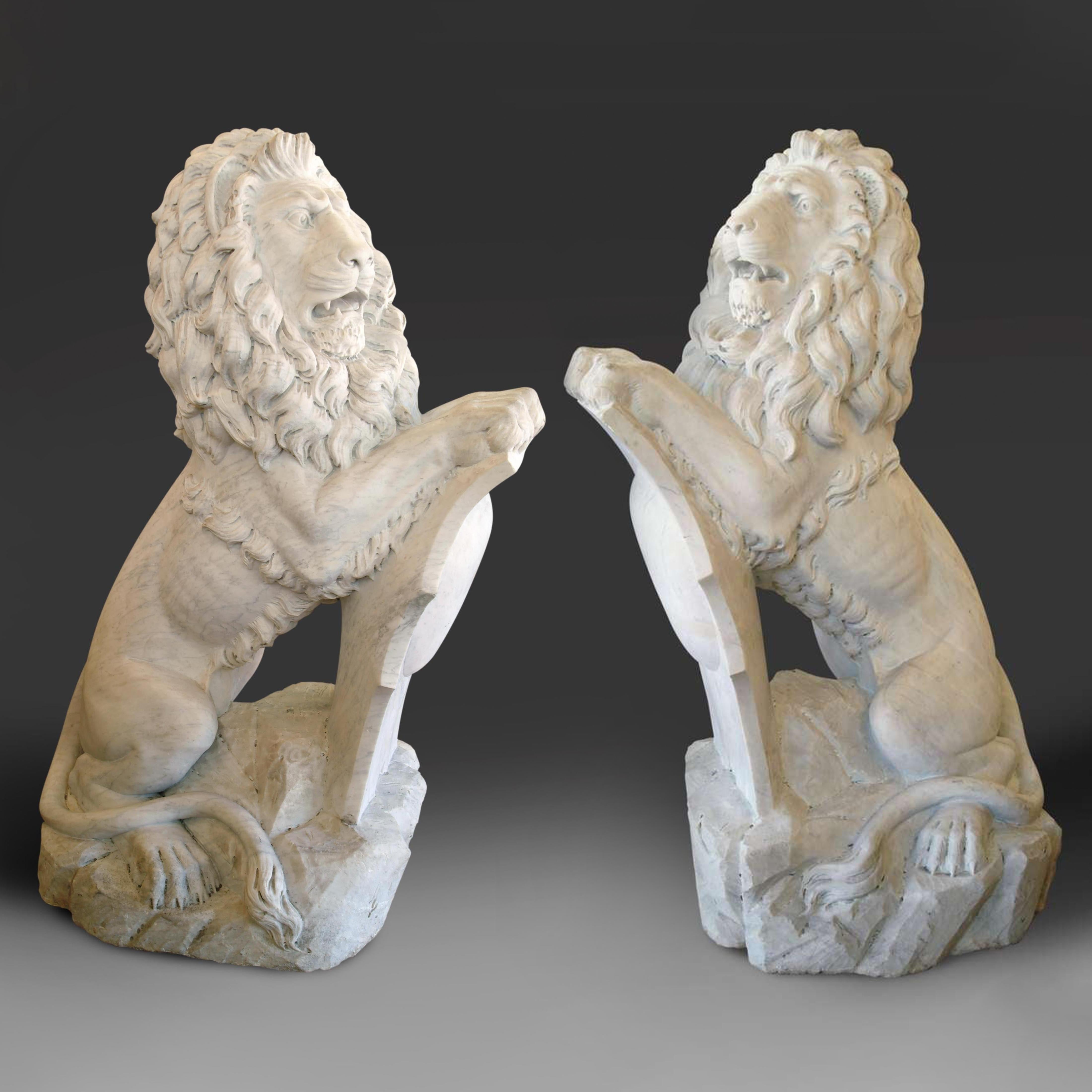 An impressive pair of life-size 19th century English Baroque style carved white marble sitting lions. each lion resting its front paws on a carved shield.
After Josef Gott.

This pair is the largest we ever had in this model.

circa