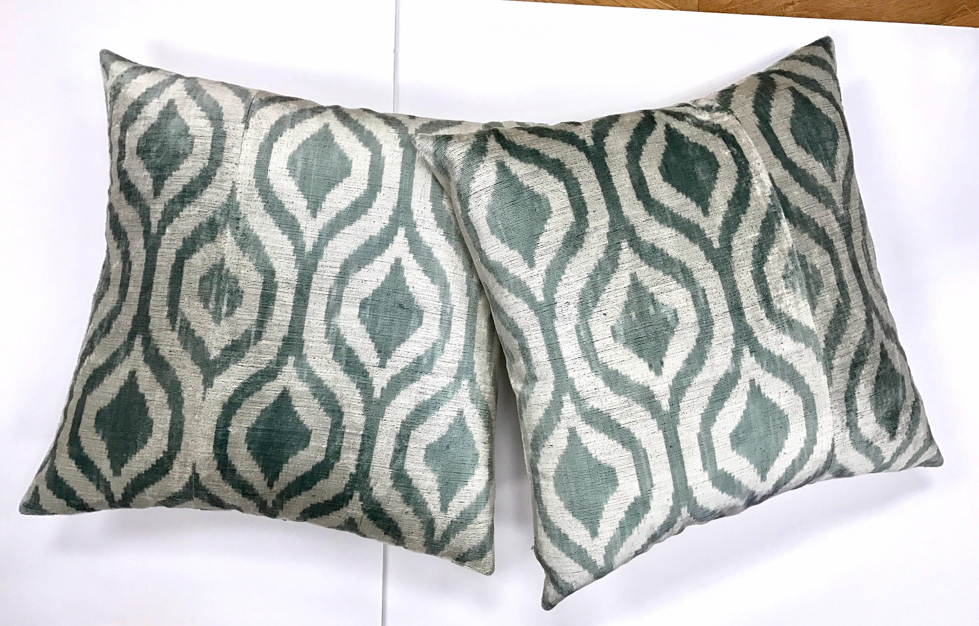 With their brilliant colors and bold design, Ikats are some of the most distinct and sought after fabrics produced in the world. This pair of handmade silk Ikat pillows are down filled and both tied and dyed by hand. This makes each Ikat design one