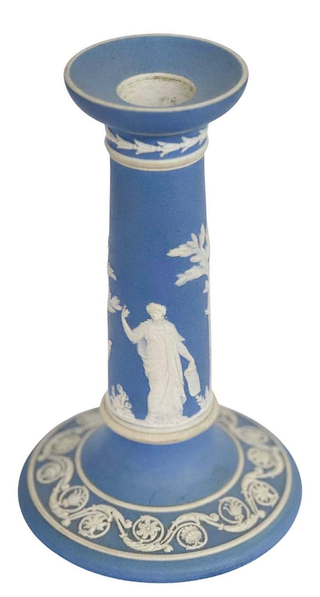 Pair of elegant light blue and white jasperware Wedgwood candlesticks with great detail all around depicting classical imagery and botanical figures. 
Made in England, c. 1920's. 
*Signed on the base 