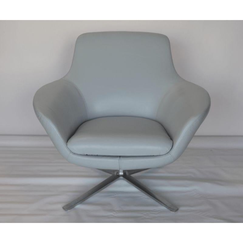 Pair of light blue leather swivel chairs by Coalesse. USA, 21st century.