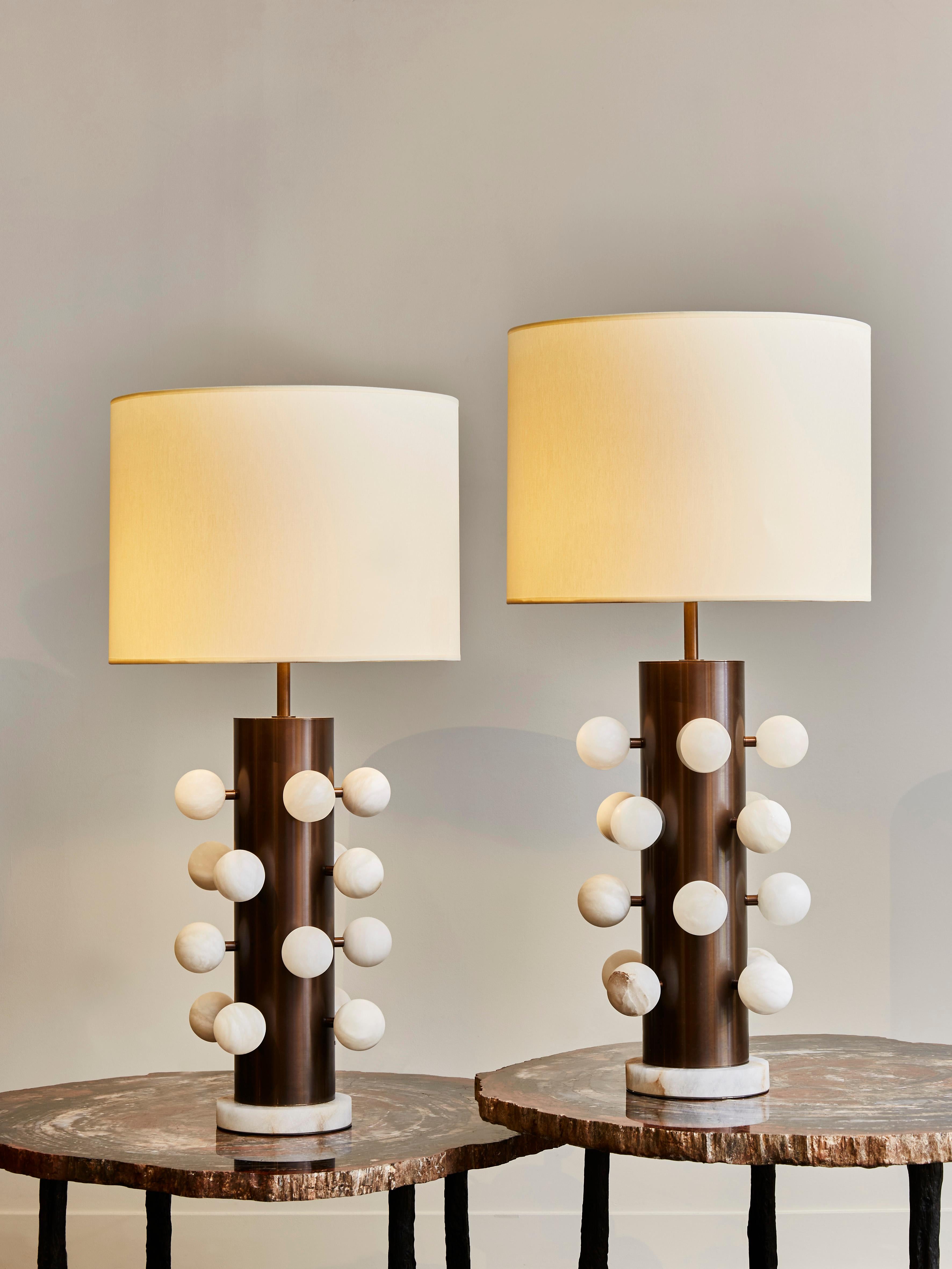 Pair of table lamps made of light bronze finished brass body, and alabaster feet and decorative spheres attached all over the lamps.

