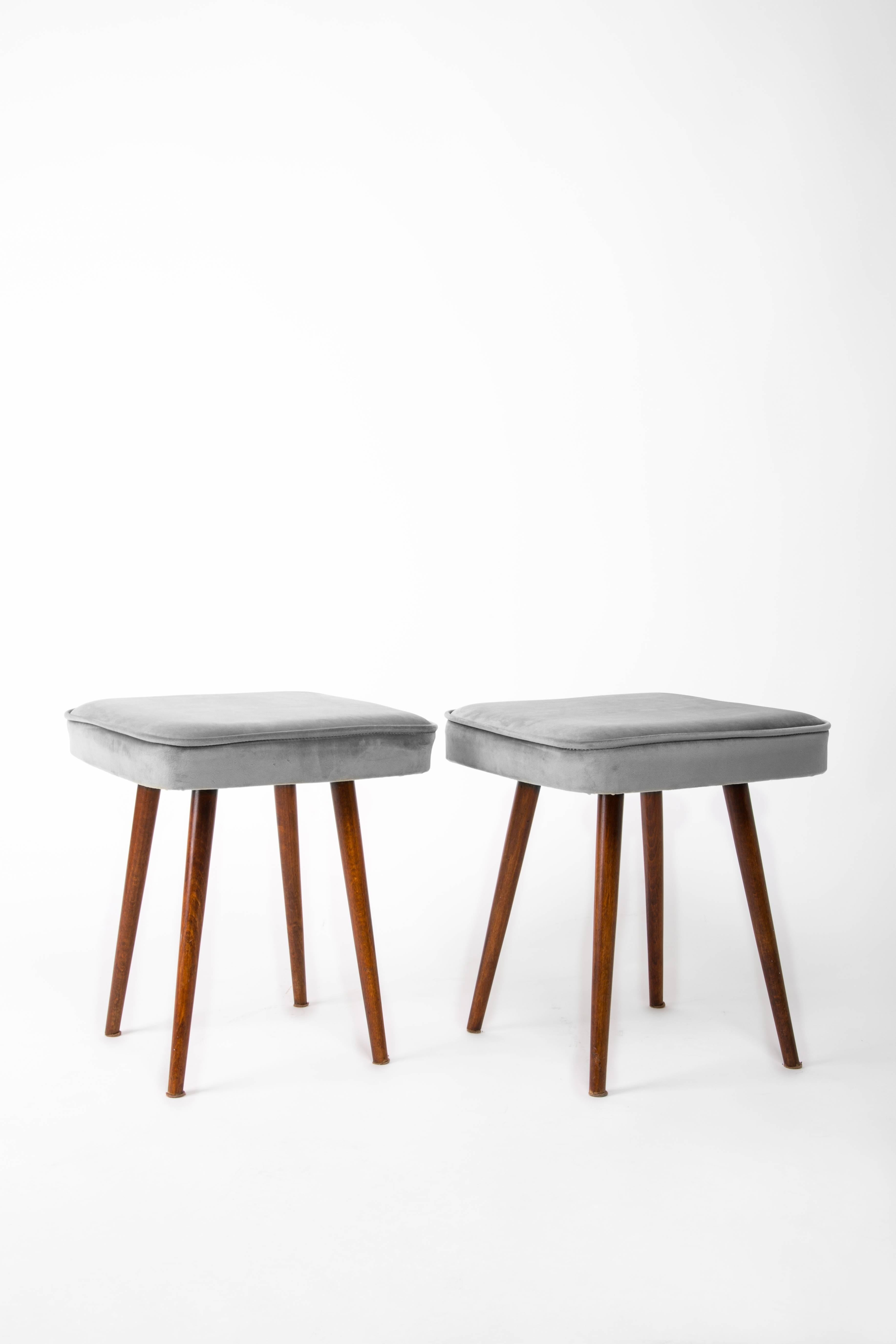 Stool from the turn of the 1960s and 1970s. Beautiful gray velor upholstery. The stool consists of an upholstered part, a seat and wooden legs narrowing downwards, characteristic of the 1960s style. We can prepare this pair also in another color of