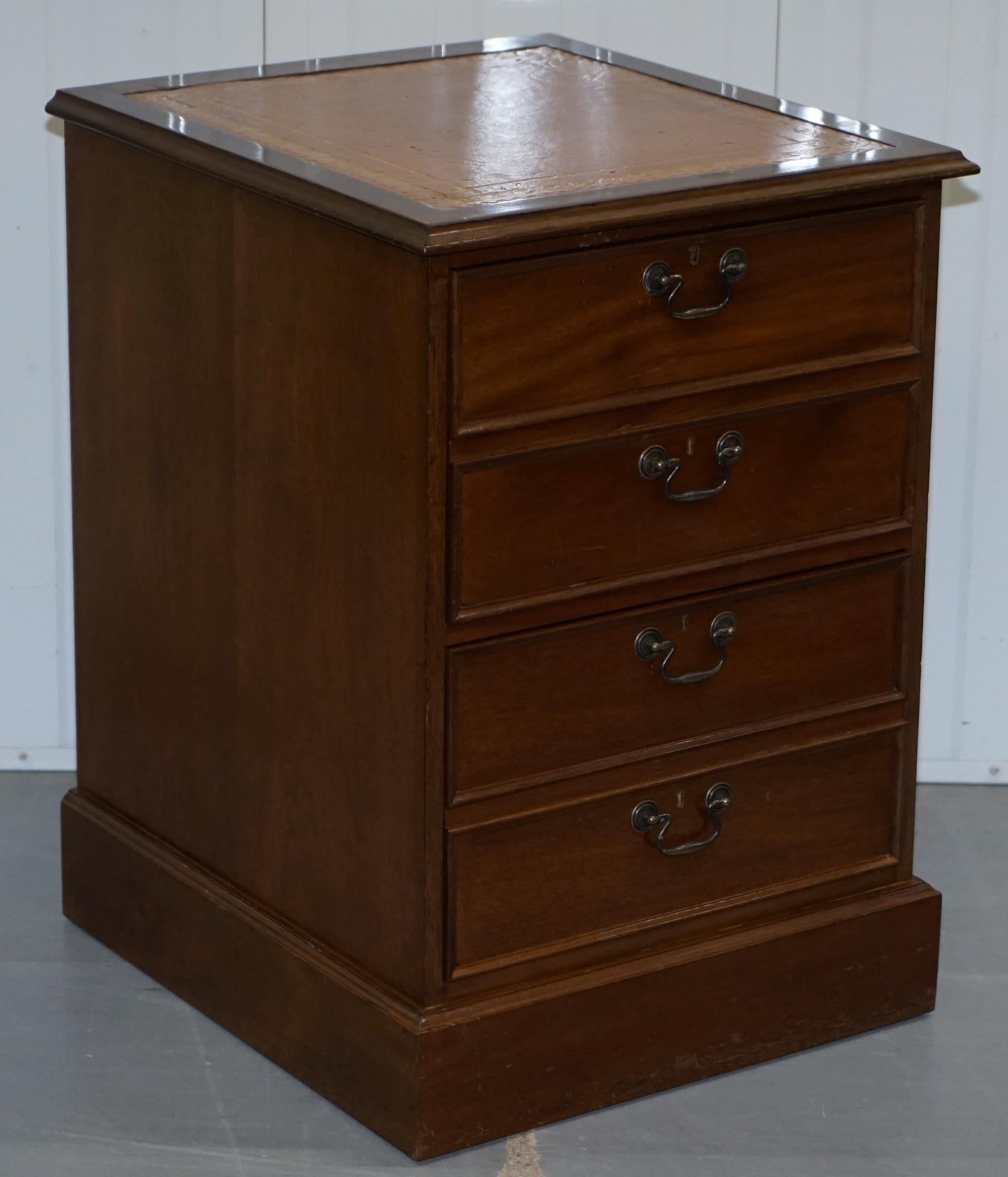 We are delighted to offer for sale this lovely pair of light mahogany pedestal filing cabinets with brown leather gold tooled cabinets

The brown leather writing surface is gold tooled and it has a nice vintage patina to it as does the mahogany