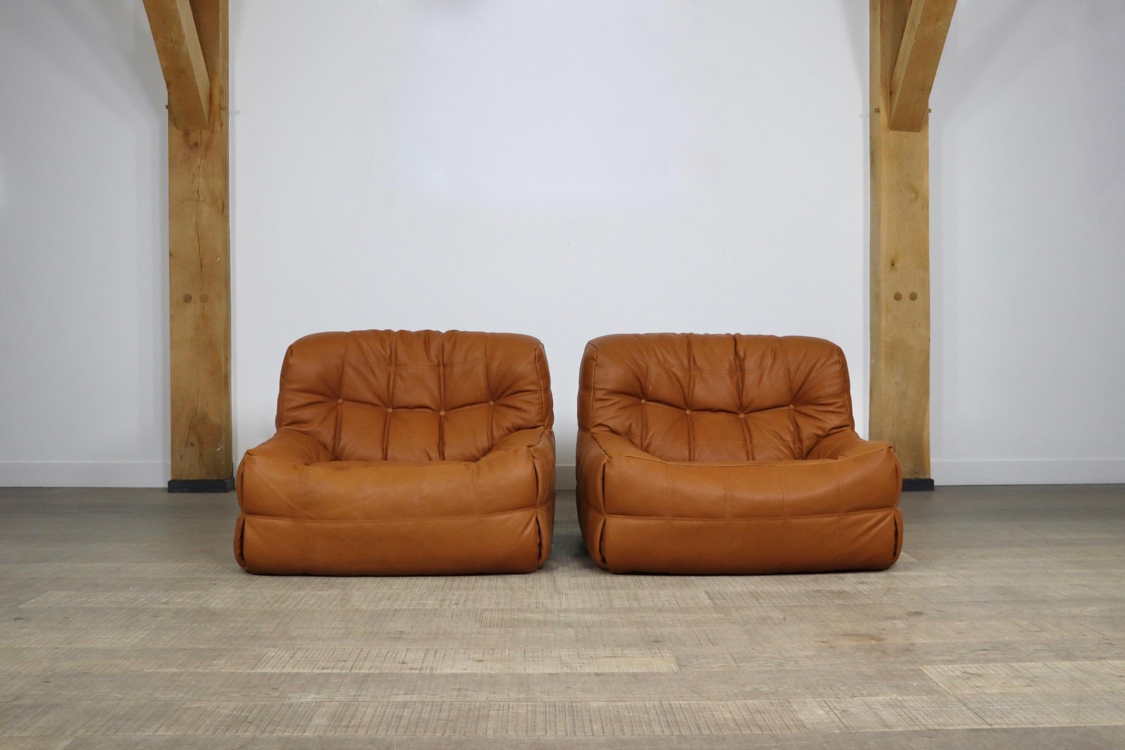 Stunning and extremely comfortable pair of Kashima lounge chairs in cognac leather by Michel Ducaroy for Ligne Roset, 1970s. These chairs have been professionally reupholstered in high quality Aniline leather which will obtain a nice patina over