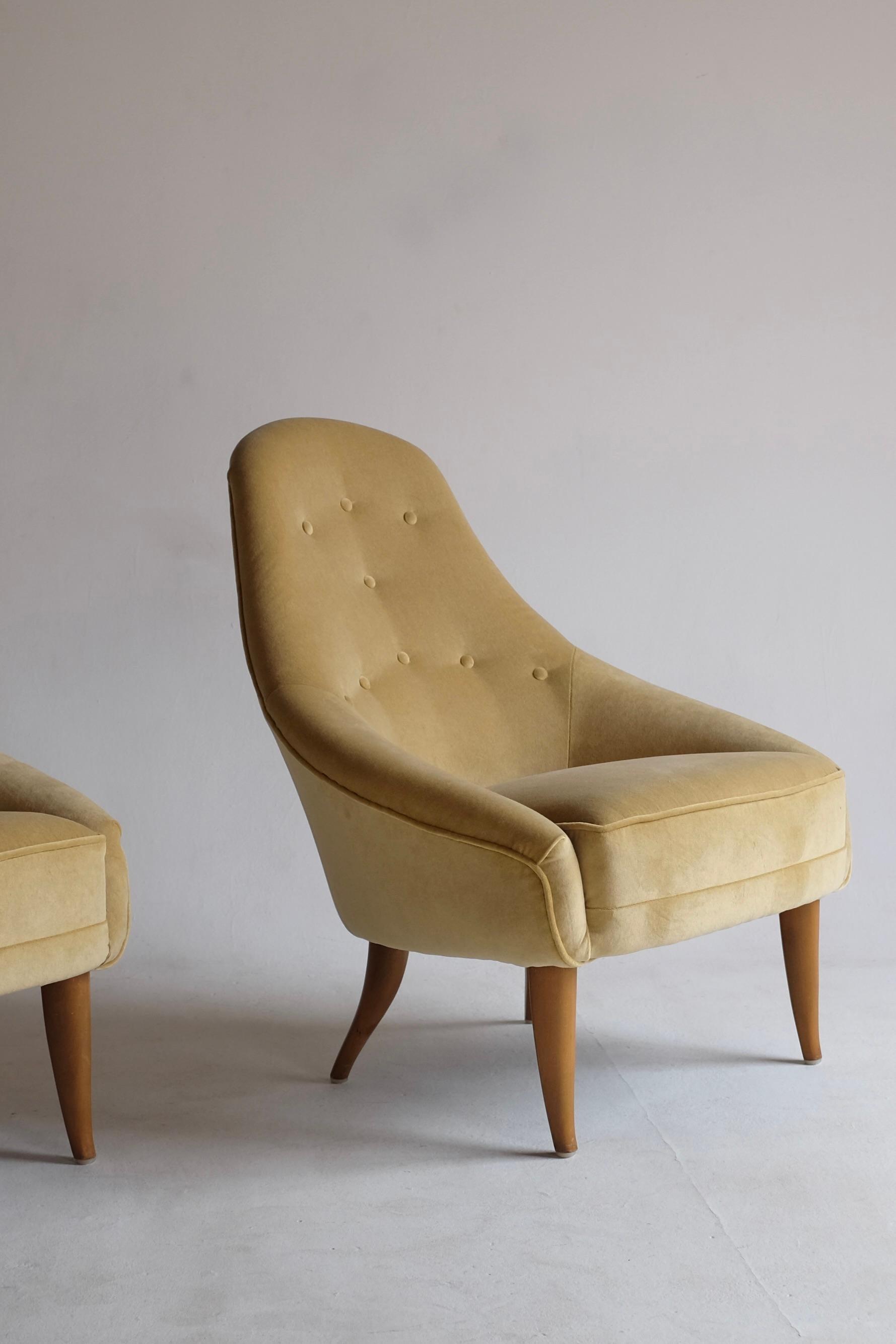 Pair of Lilla Eva Lounge Chairs by Kerstin Hörlin-Holmquist, created in the mid 1950's for Nordiska Kompaniet and part of the Paradiset collection. This Swedish mid-century icon bears her signature look of a light and gracious design. Newly