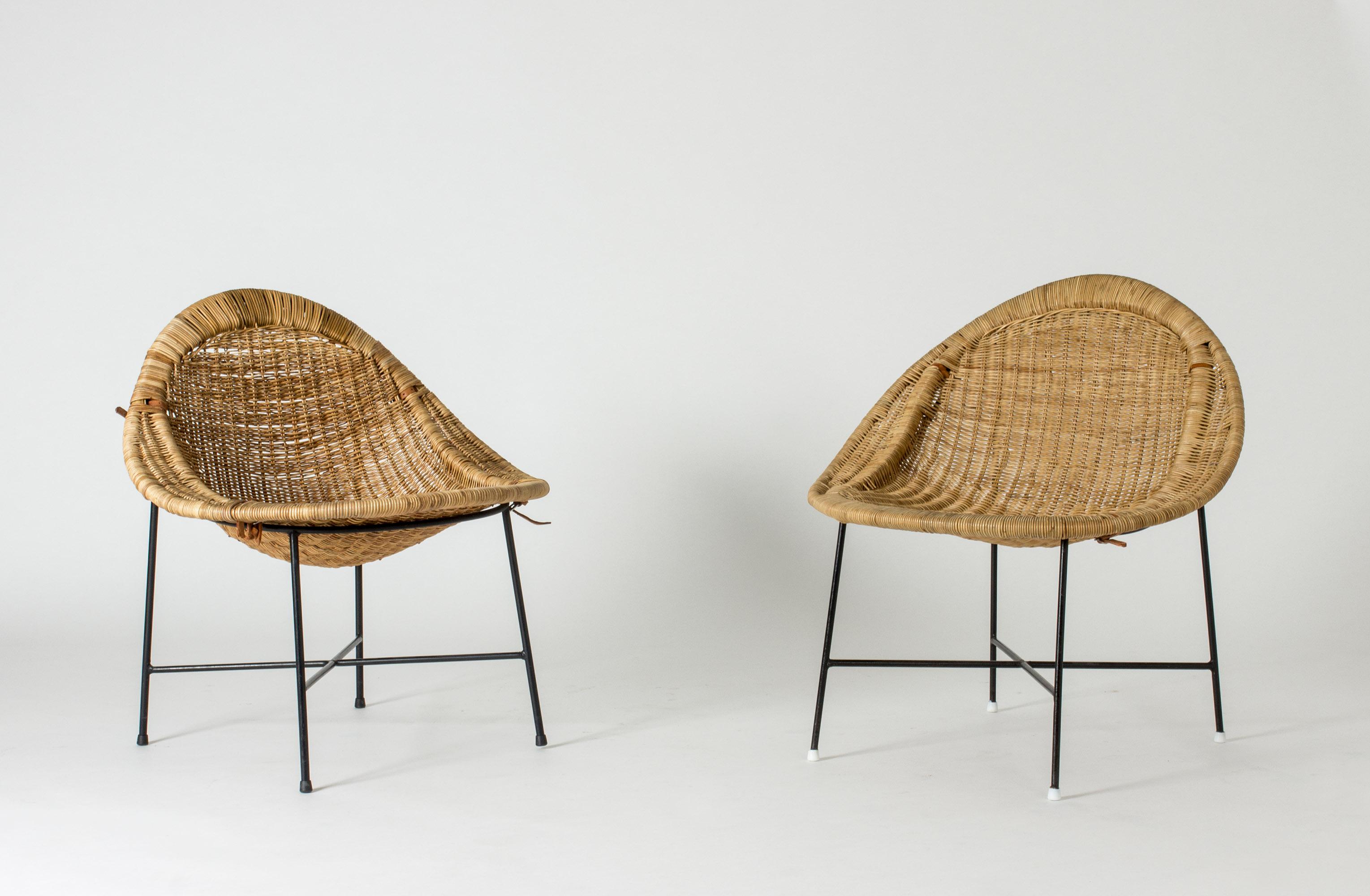 Pair of “Lilla Kraal” lounge chairs by Kerstin Hörlin-Holmquist, made from wreathed rattan on lacquered metal bases. One of the chairs is mended on the back, see the last image. 

The design is inspired by traditional African village enclosures