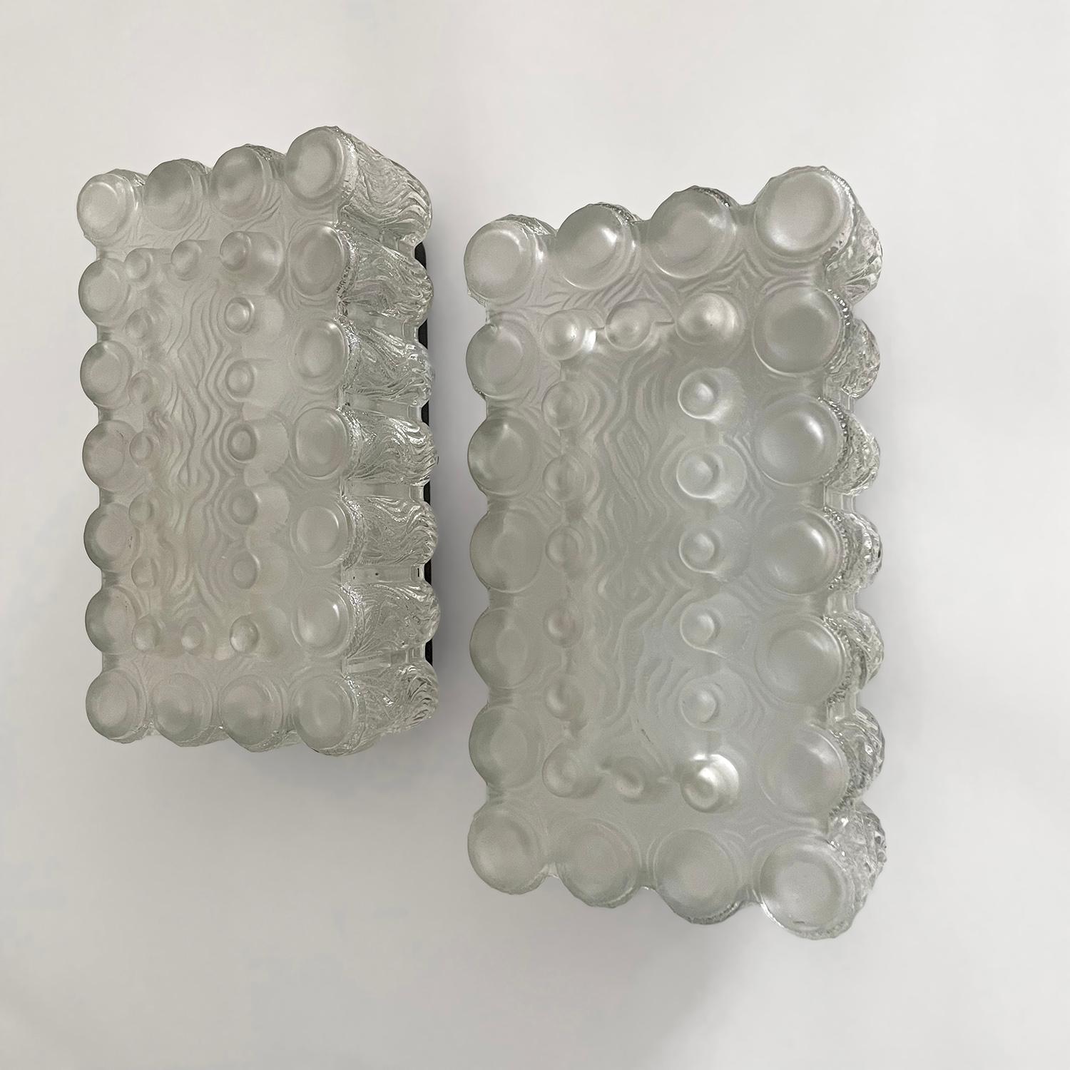 Limburg textured ice glass bubble sconces
Germany, circa 1960’s
Beautifully molded contrasting glass shades illuminate light beautifully 
The front part of each glass shade is crafted from textured frosted glass and the sides are comprised of