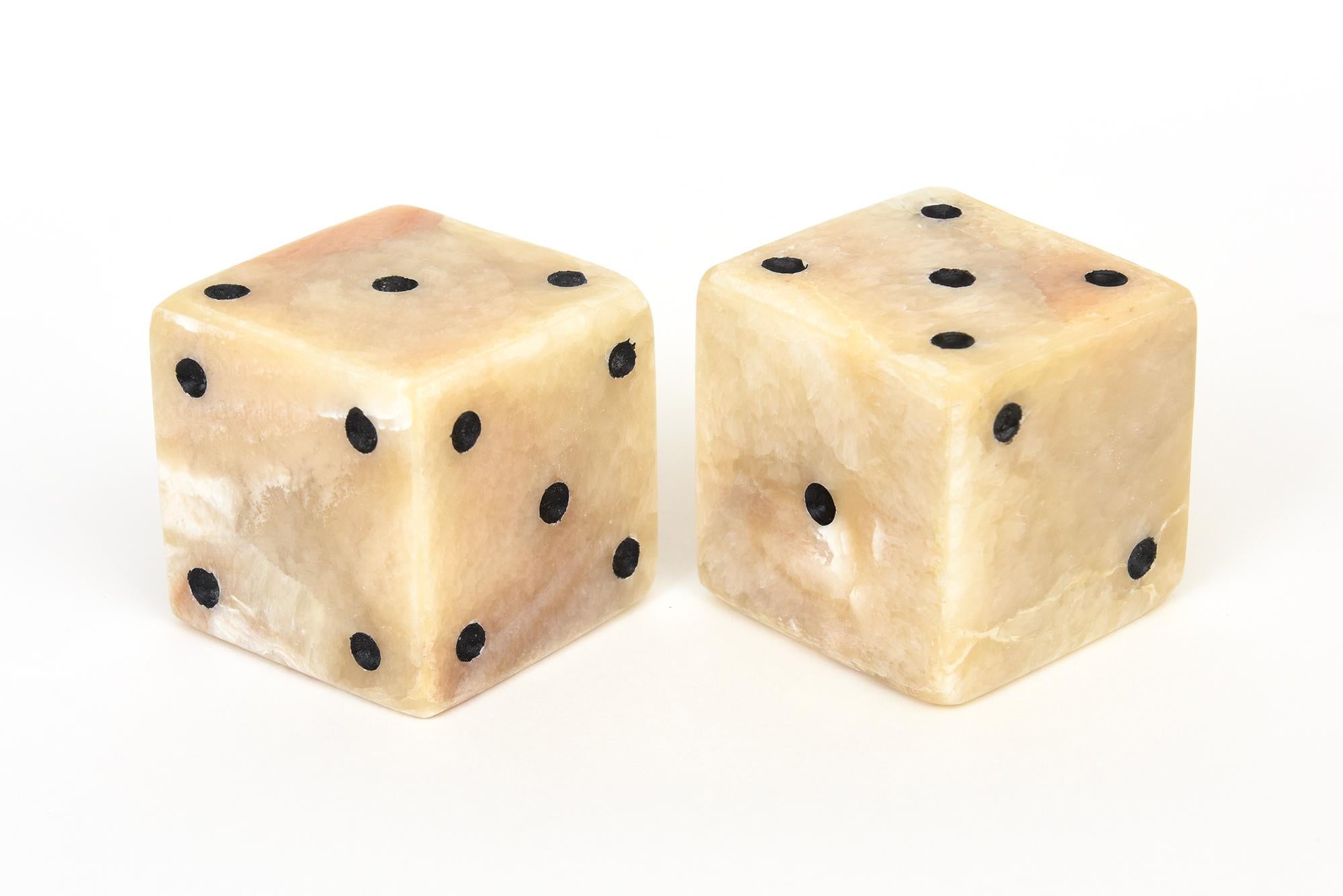 Offering for you are a fabulous pair of square contemporary limited edition onyx dice sculptures for your cocktail table, console or desk. The different variants are normal to the stone. Onyx is the parallel banded variant of chalcedony much like an