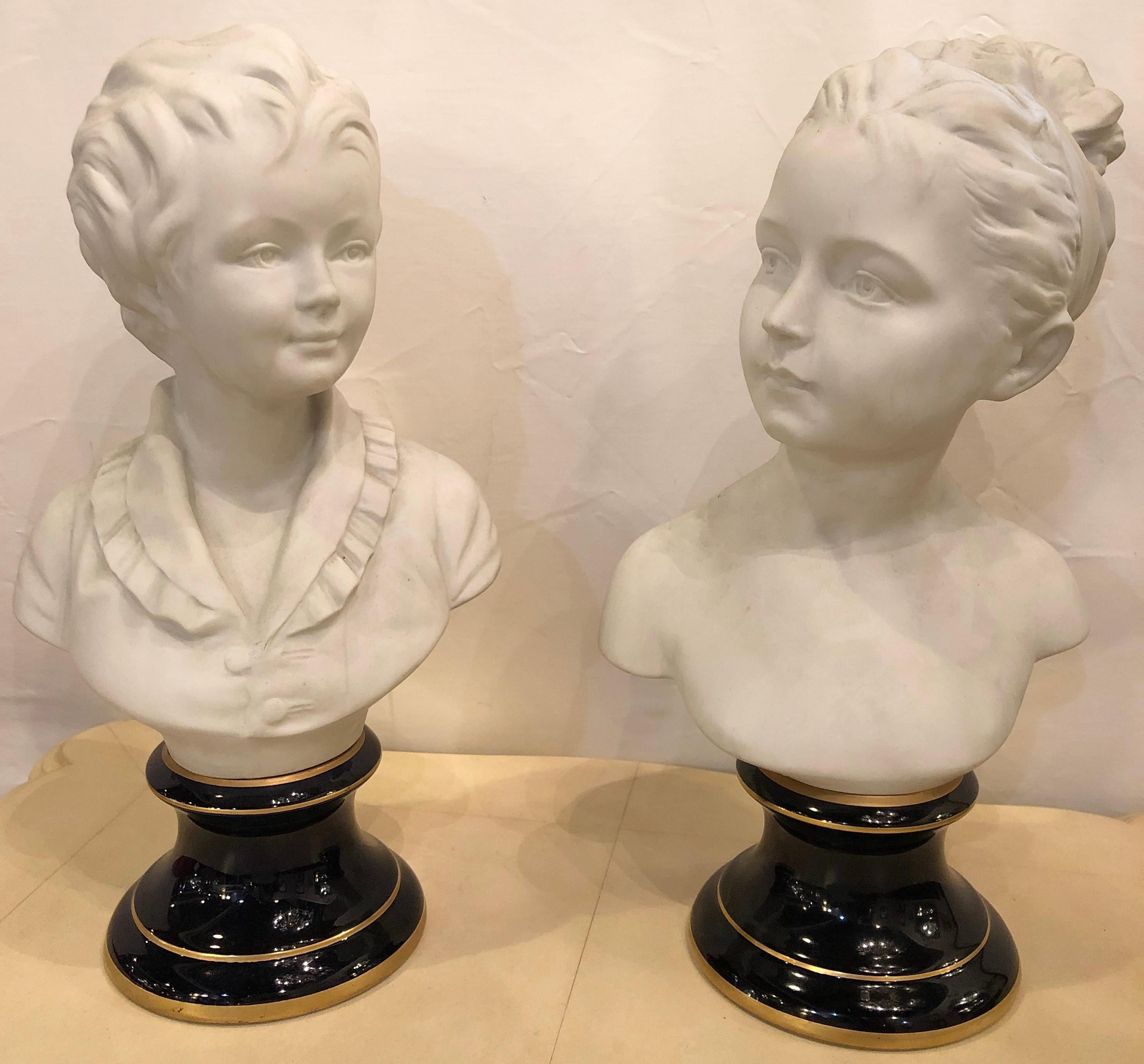 A fine pair of Limoges porcelain and Parian busts of two young children, very well detailed and standing on cobalt blue ceramic bases with a gilded ring decoration. This lovely and sweet brother sister team are Stamped Fharaud on the