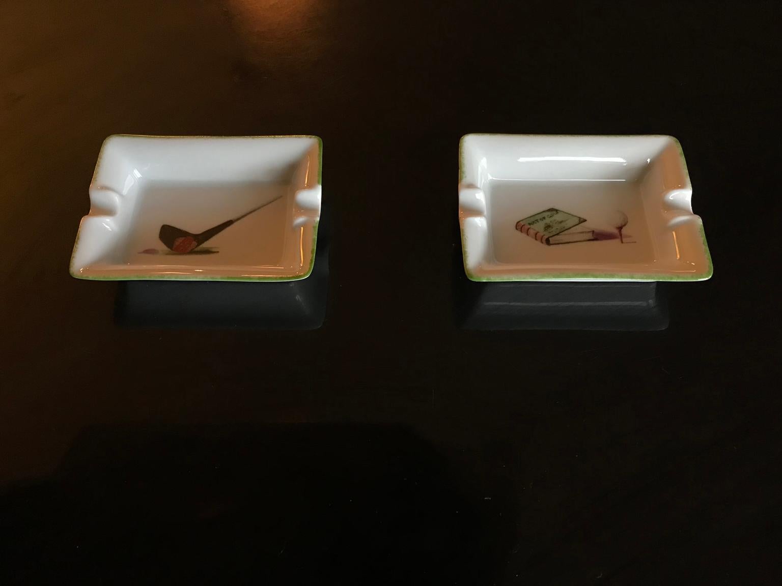 Pair of Limoges porcelain ashtrays in hand painted golf decoration, presented in lovely orange boxes.


