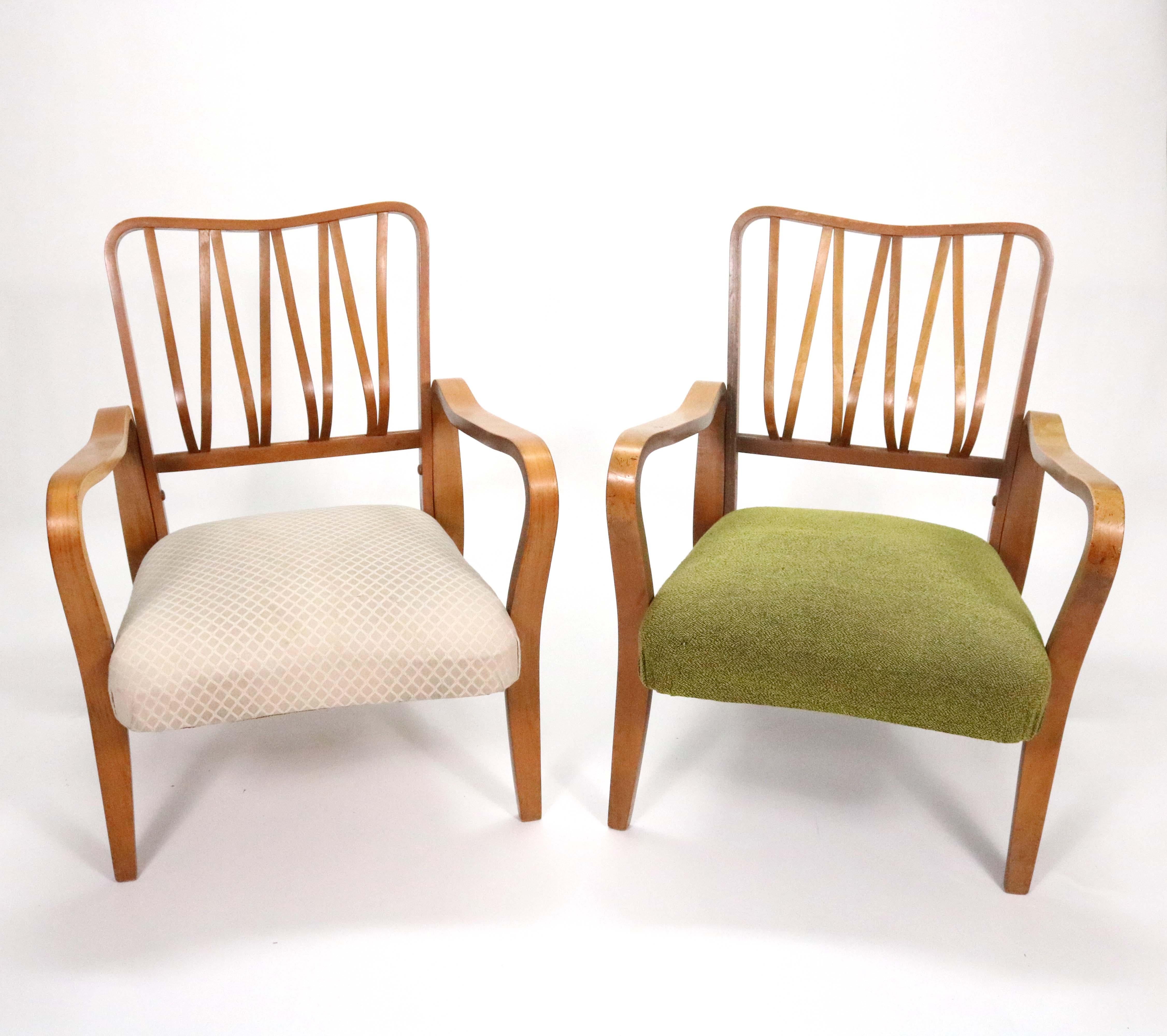 A pair of elegant beechwood Linden Arm Chairs designed by G. A. Jenkins & Eric Lyons for Packet Furniture in 1948 and manufactured in the 1950s. 

Professional reupholstery and refinishing available at pass-through costs.
