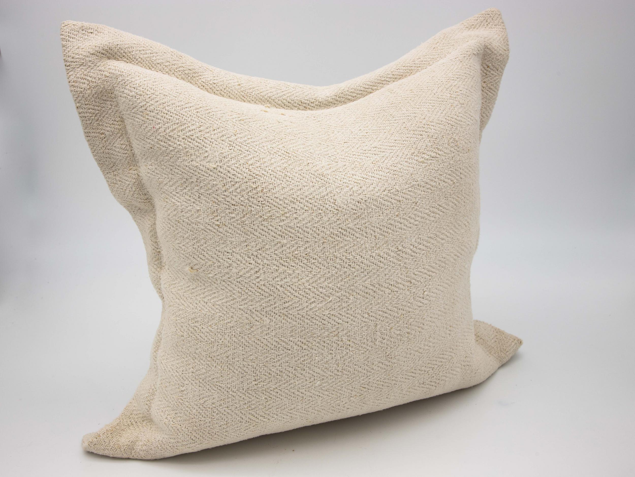 A pair of 20 x 20 pillows made from antique Belgian linen. A large flange finish with down fill. Button closure on the reverse.