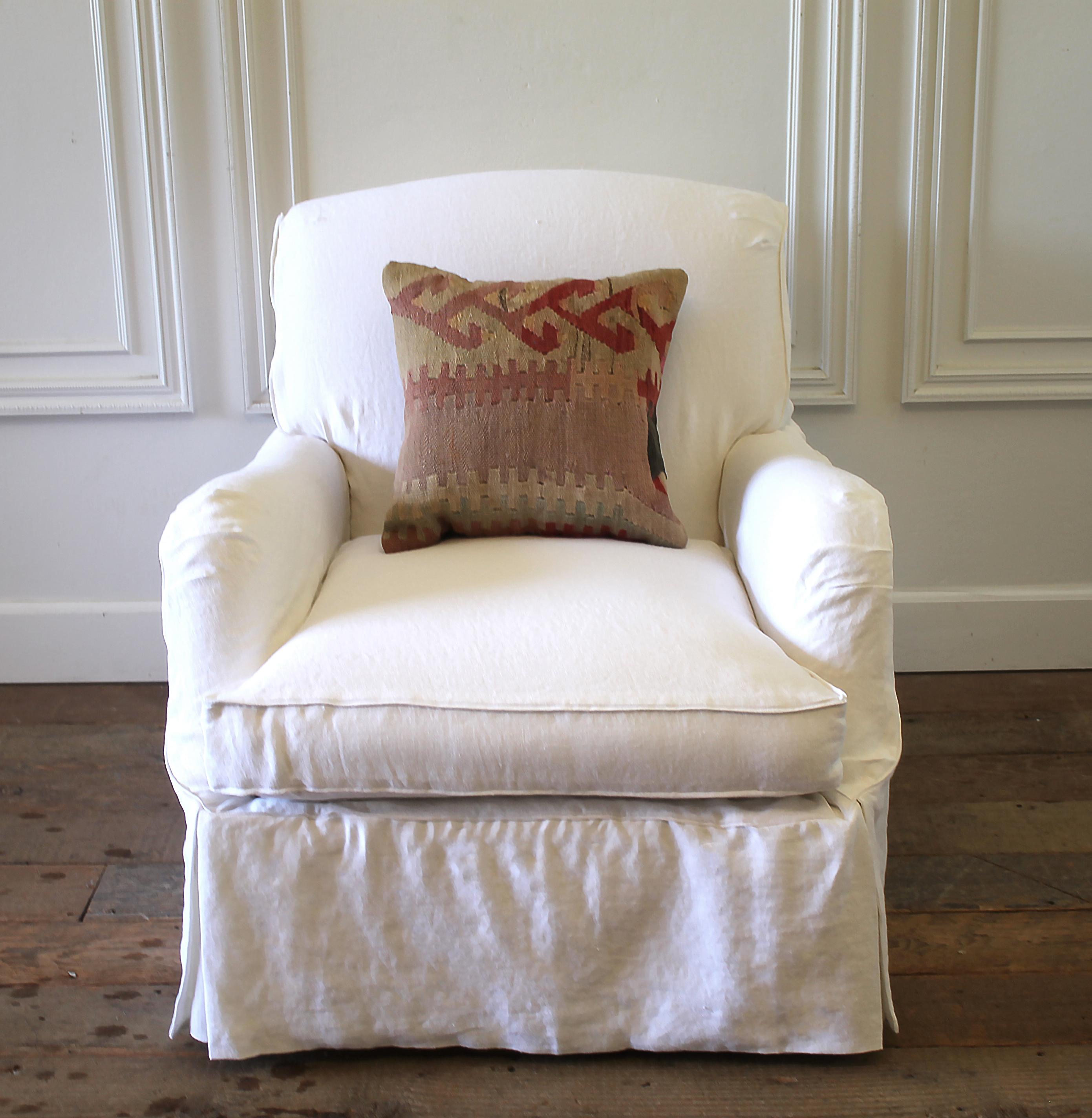 Pair of linen slip covered English roll armchairs.
Pure white Belgian washed linen with down cushions. Extremely comfortable to sit it. Chairs are newer upholstery underneath in plain canvas. Each chair has rollers, that can be removed, but they