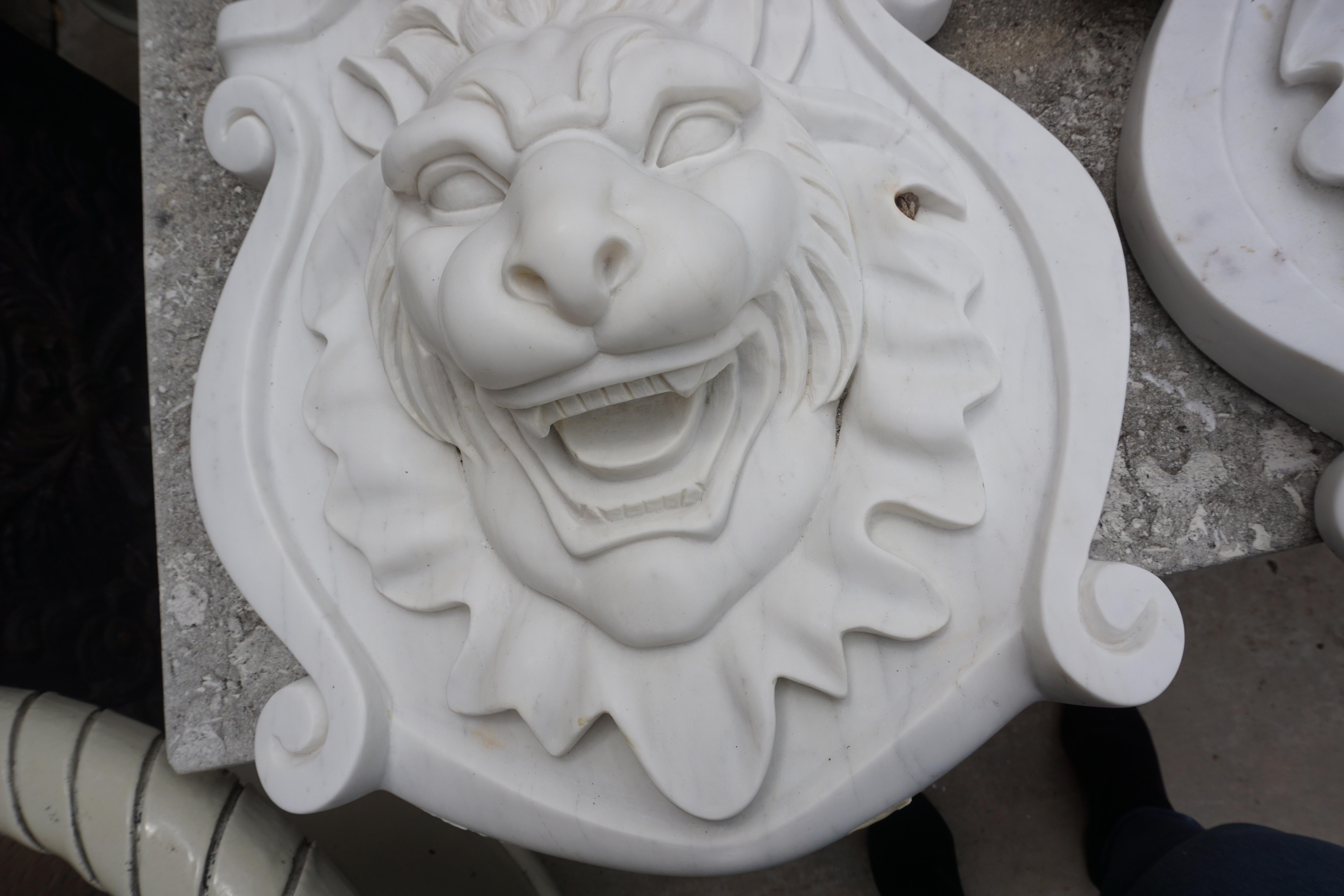 This pair of hand carved stone head plaques depict lions and originate from Italy, circa 1920. 

Measurements: 21'' L x 18'' W x 6'' D.