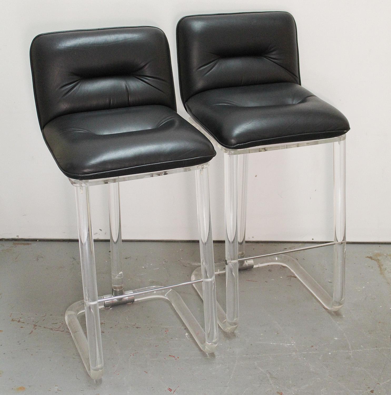Timeless pair of black leather, lucite, and chrome swivel bar stools 
by Leon Frost for Lion in Frost. 

Expand your exiting collection or add to a small bar/ eating area.