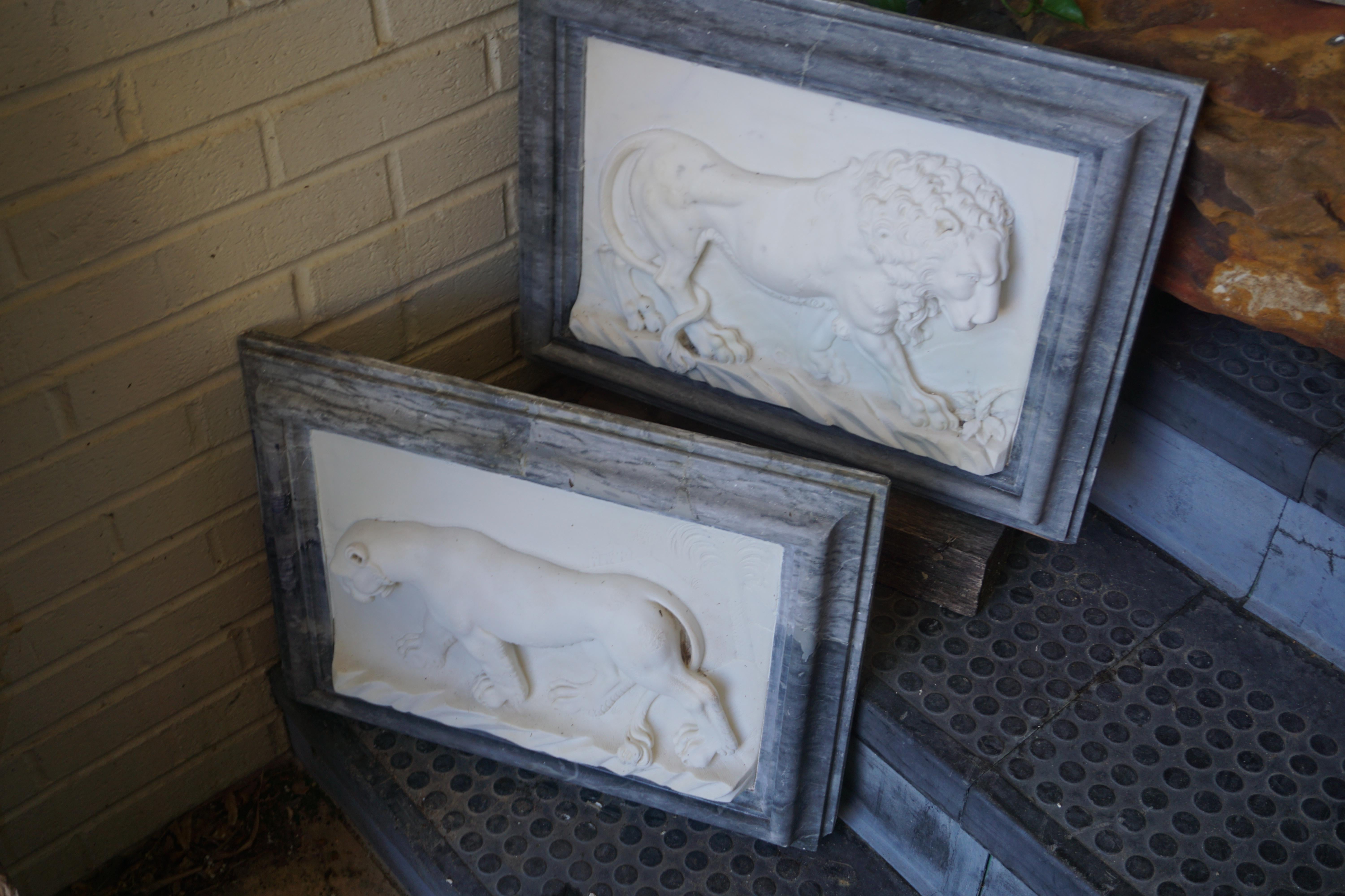 This pair of marble plaques features detailed carvings of wild cats in their natural habitat. They originate from Italy, circa early 18th century.
 